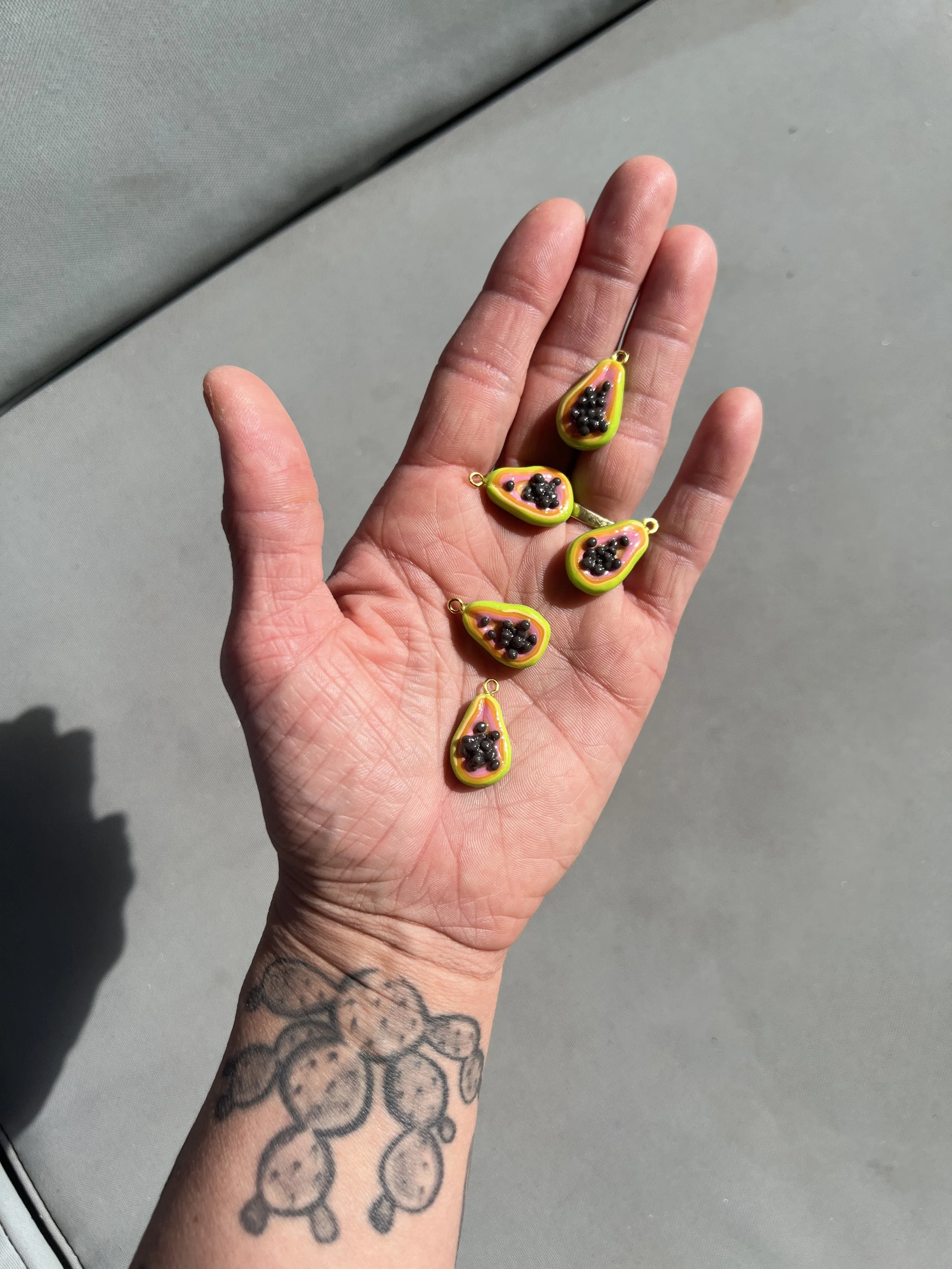mini handmade papaya fruit charms held in hand
