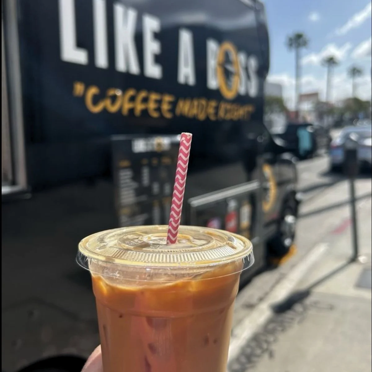 Iced coffee in front of Like A Boss coffee truck