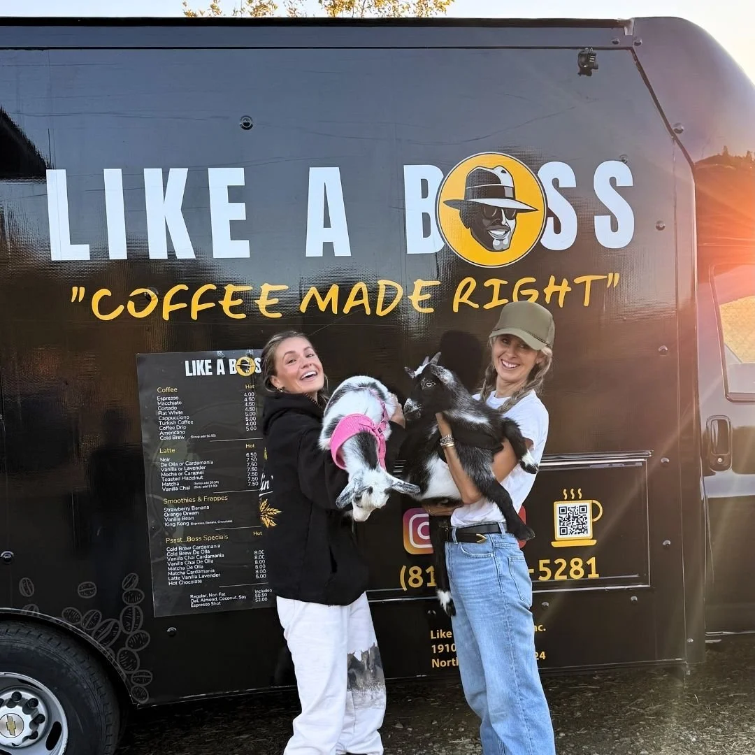 Ladies with goats on location in front of coffee truck