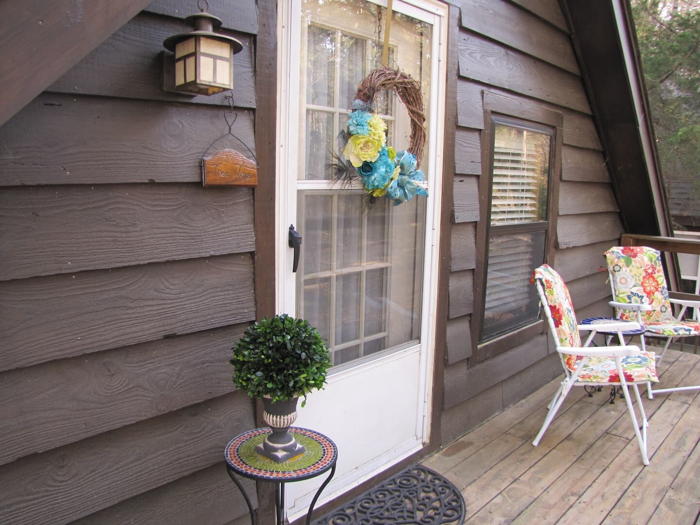 Welcome to Tree Tops Cabin Studio. This is the private entrance to your room. There is an outside staircase leading up to this deck from the bottom floor..jpeg