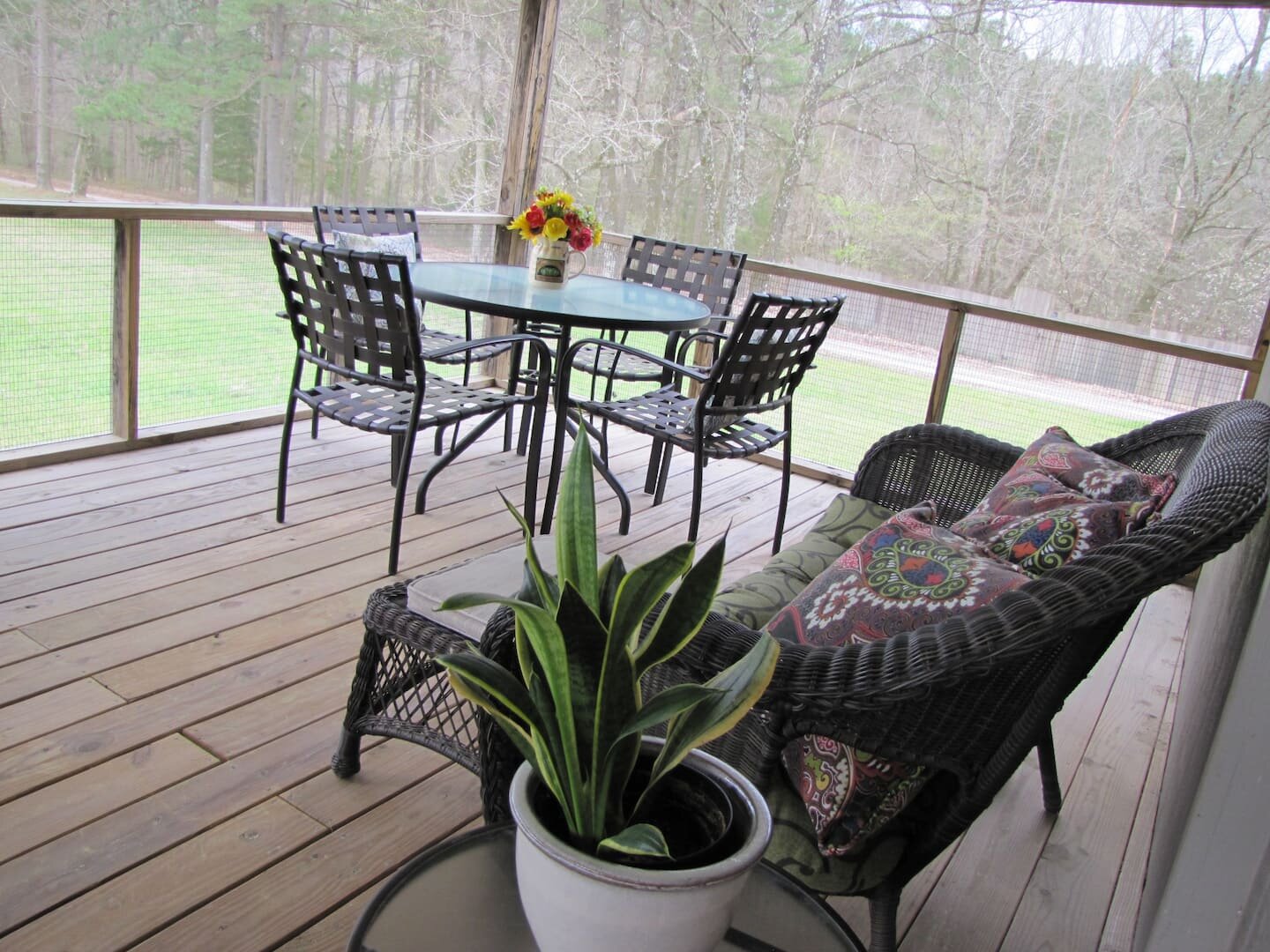 The shared screened in porch deck. A perfect place for morning coffee. There is a door leading outside from this porch and another outside door in the front of the building..jpeg