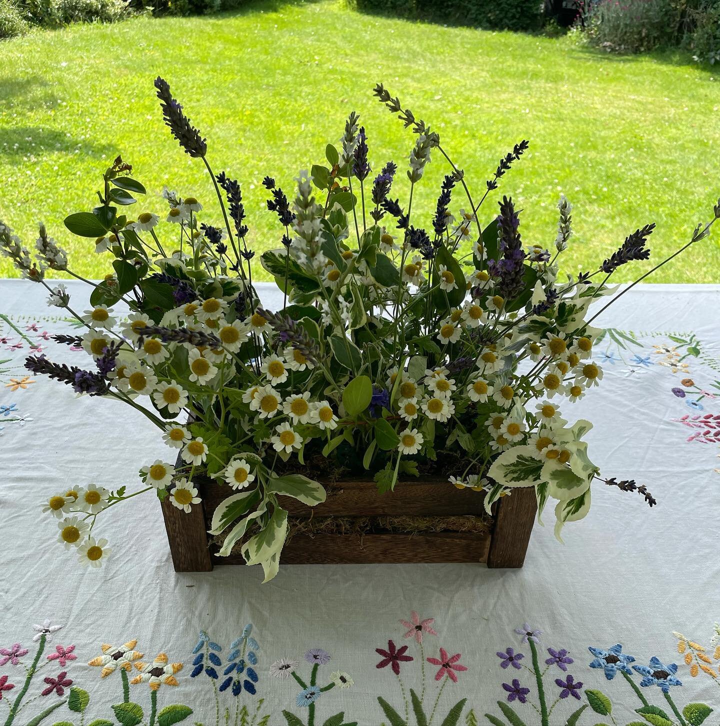 Refreshing the table flowers. 
Must get on with some work but cool under the gazebo! 
🌸🌱🌼🌱🌸
#embroideredtablecloth 
#tabledecoration 
#summertable
#summerflowers
#flowers
#gardenflowers 
#lavender