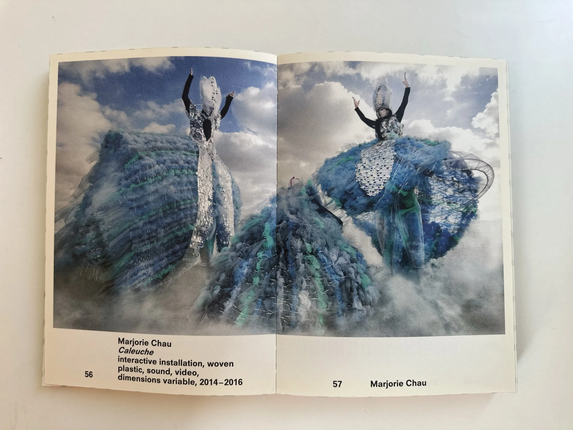 Inside Lottozero 2016 spread featuring Marjorie Chau’s sculptural costume performance against a cloudy sky.