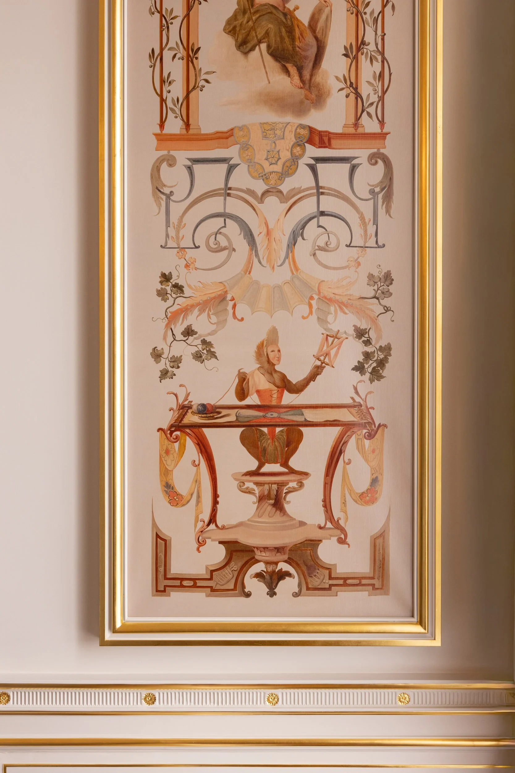 A decorative framed artwork featuring a pastoral scene with a woman wearing a flowing dress and bonnet, sitting at a writing desk, surrounded by intricate floral and scroll motifs with a soft, pastel color palette.