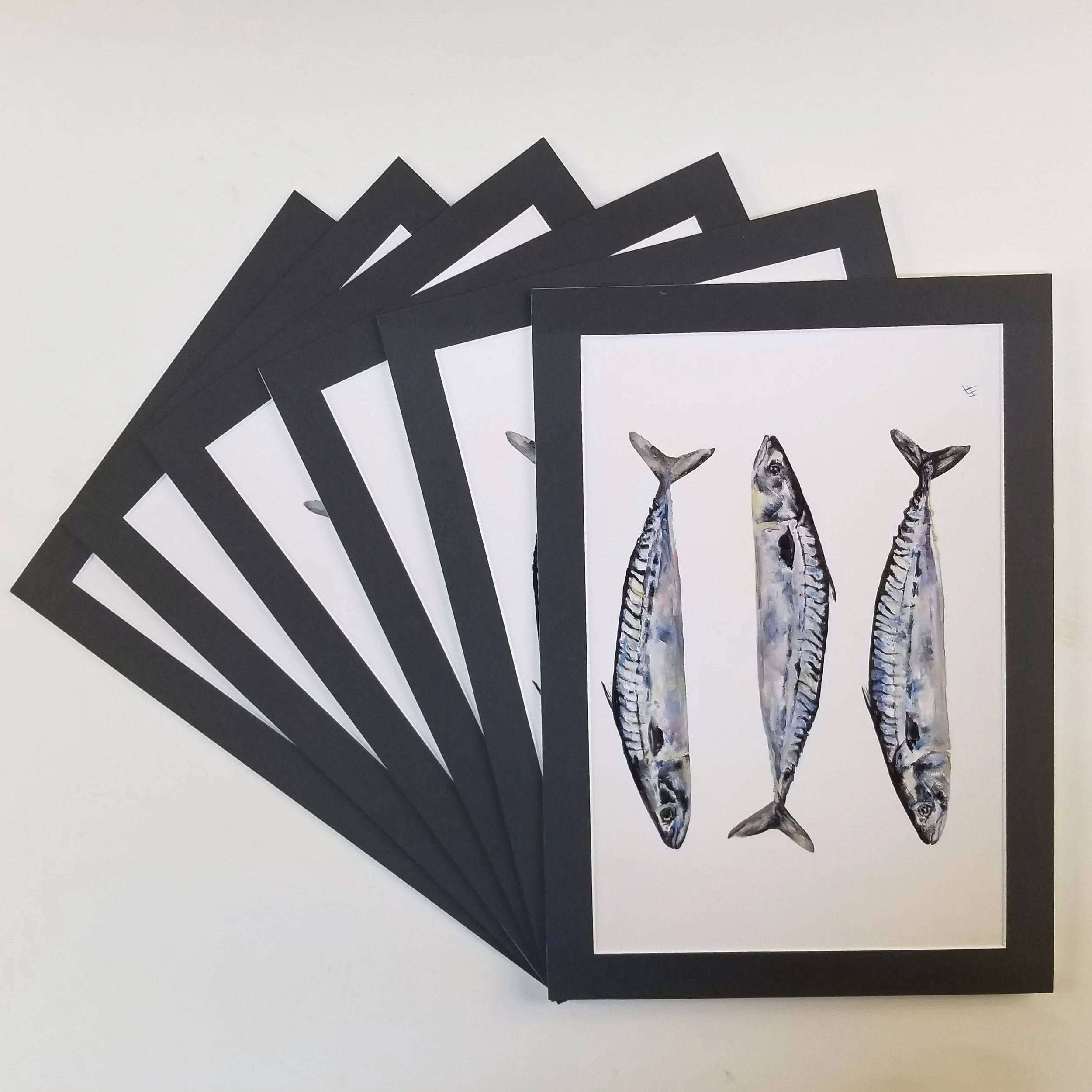 Six prints of fish, framed with black borders, displayed on white background with one print on top and five prints partially behind.