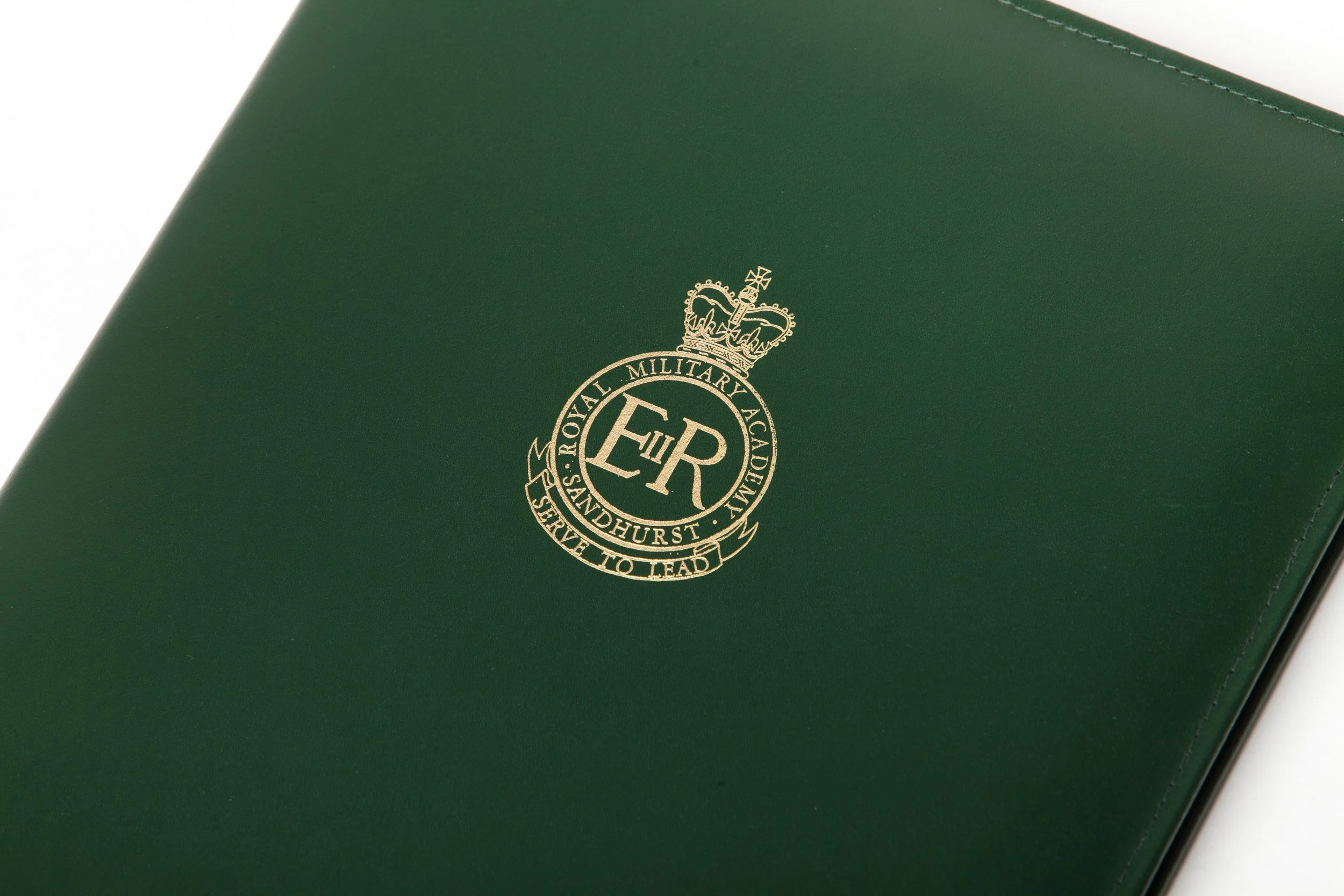 Green folder with gold Royal Military Academy Sandhurst emblem and motto 'Serve to Lead'