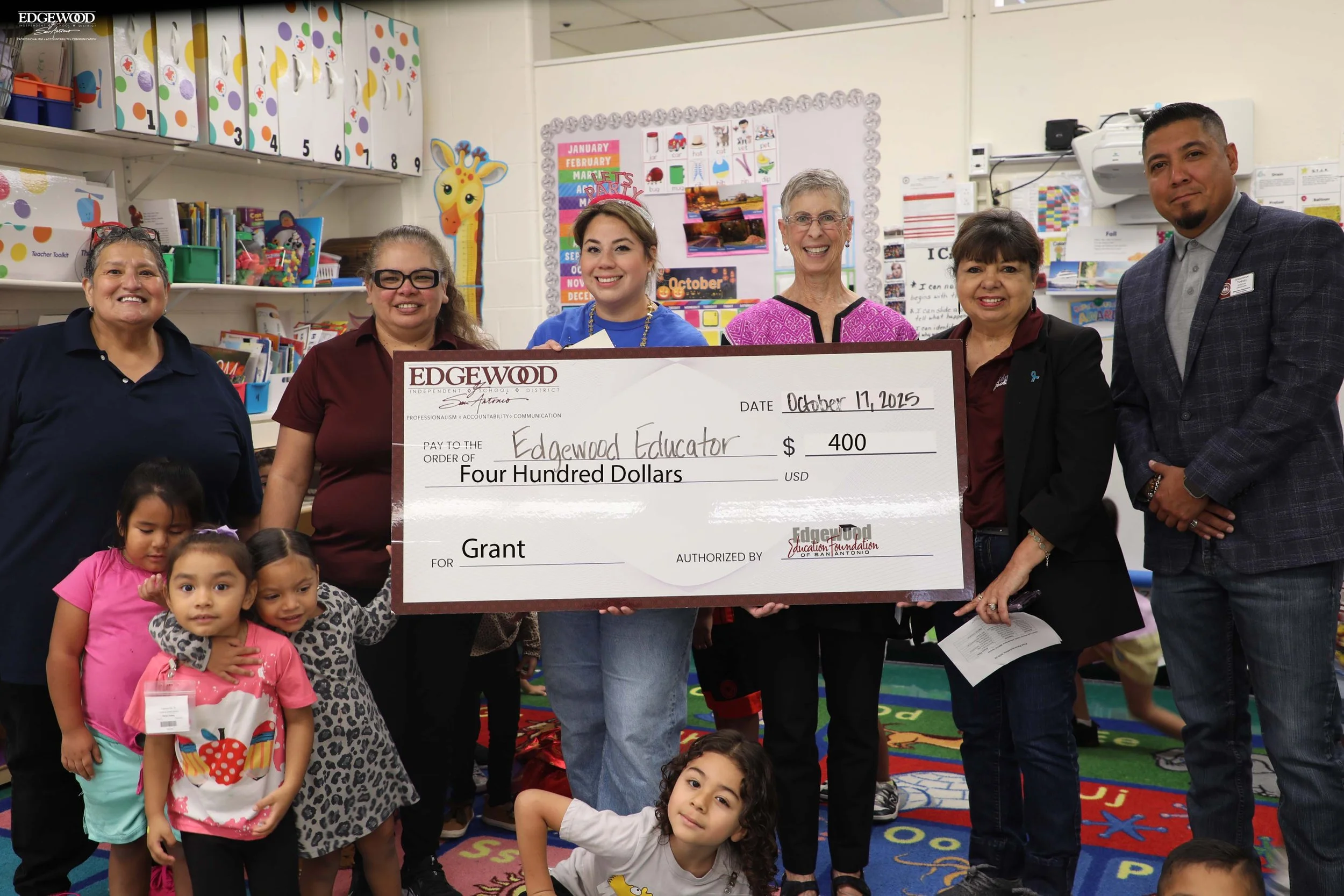 Foundation members present Grant check to teacher at Cardenas ECC