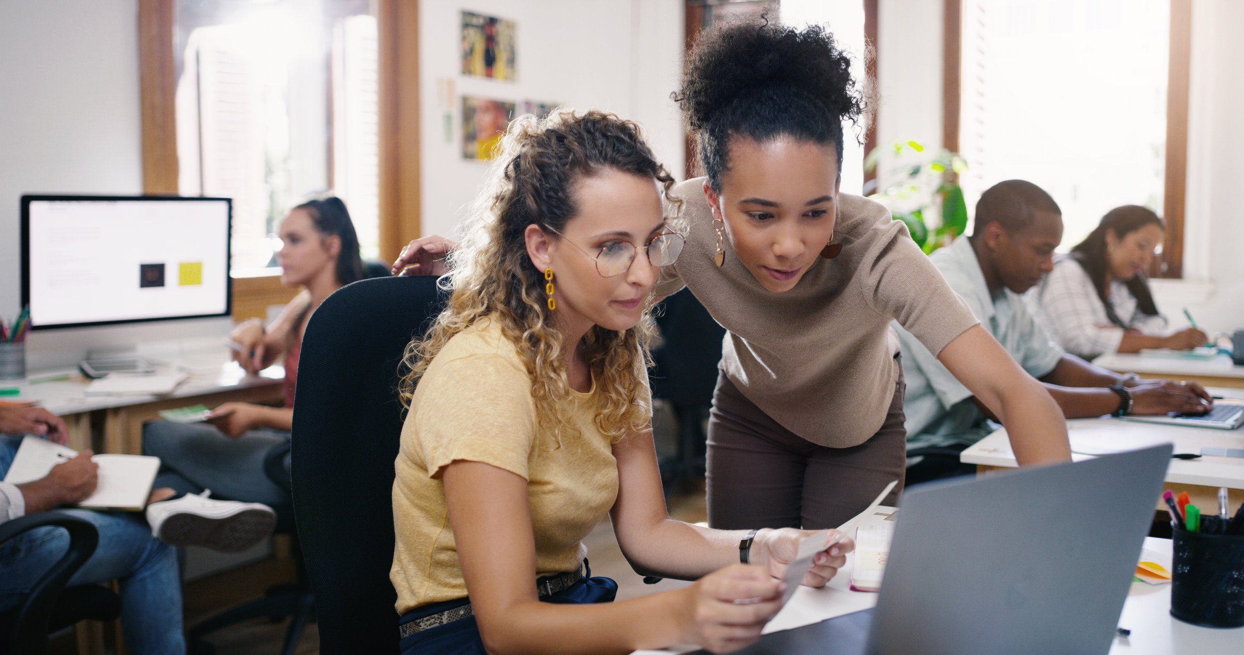 Two girls looking at a laptop