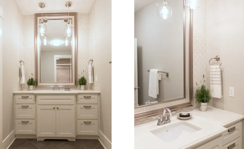 An upscale hall bathroom with a bump out sink, a white glazed arabesque tile backsplash, a full length mirror hung to the ceiling and double pendant lights.