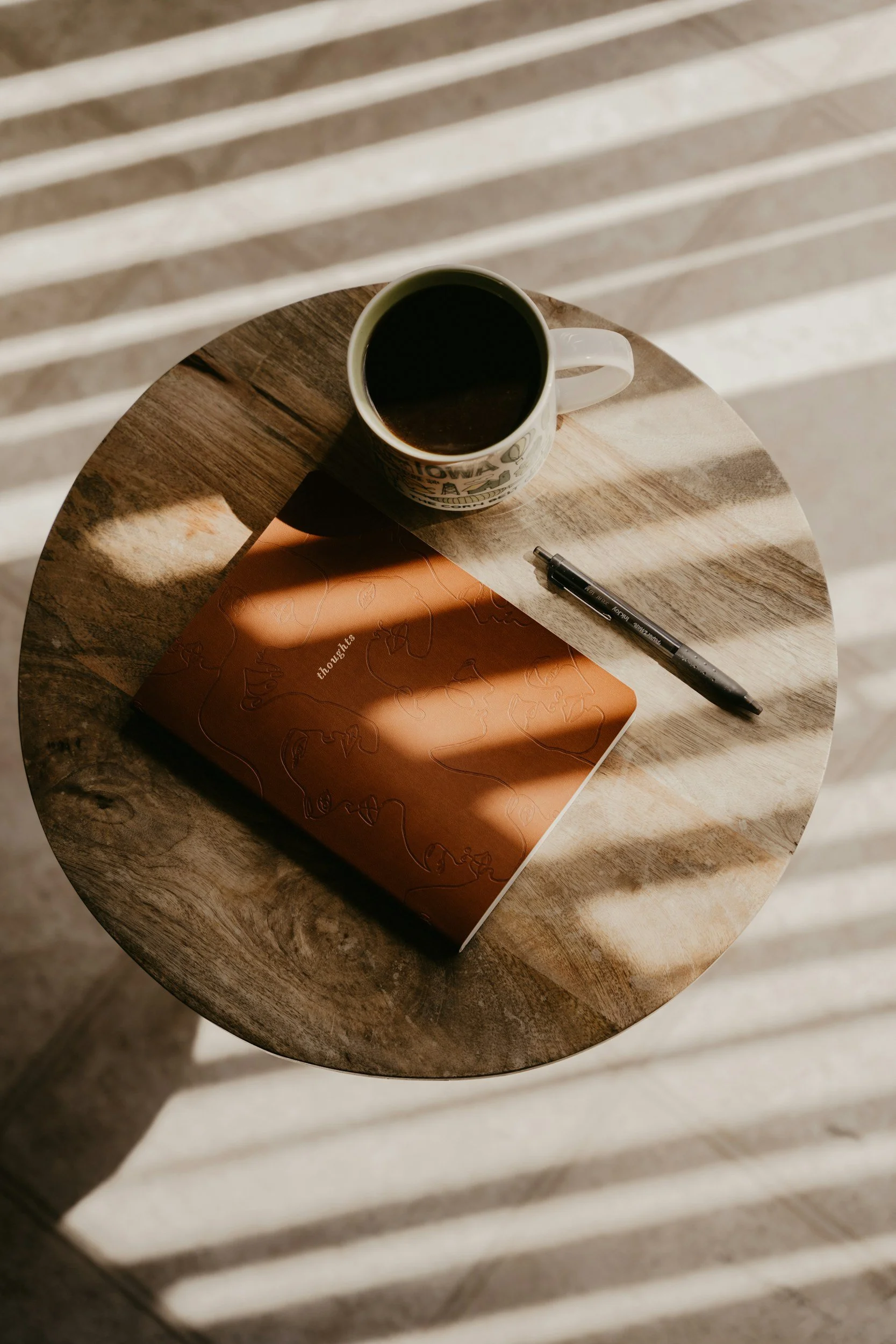 A brown journal besides a cup of dark tea – a way to find clarity when dealing with frustration