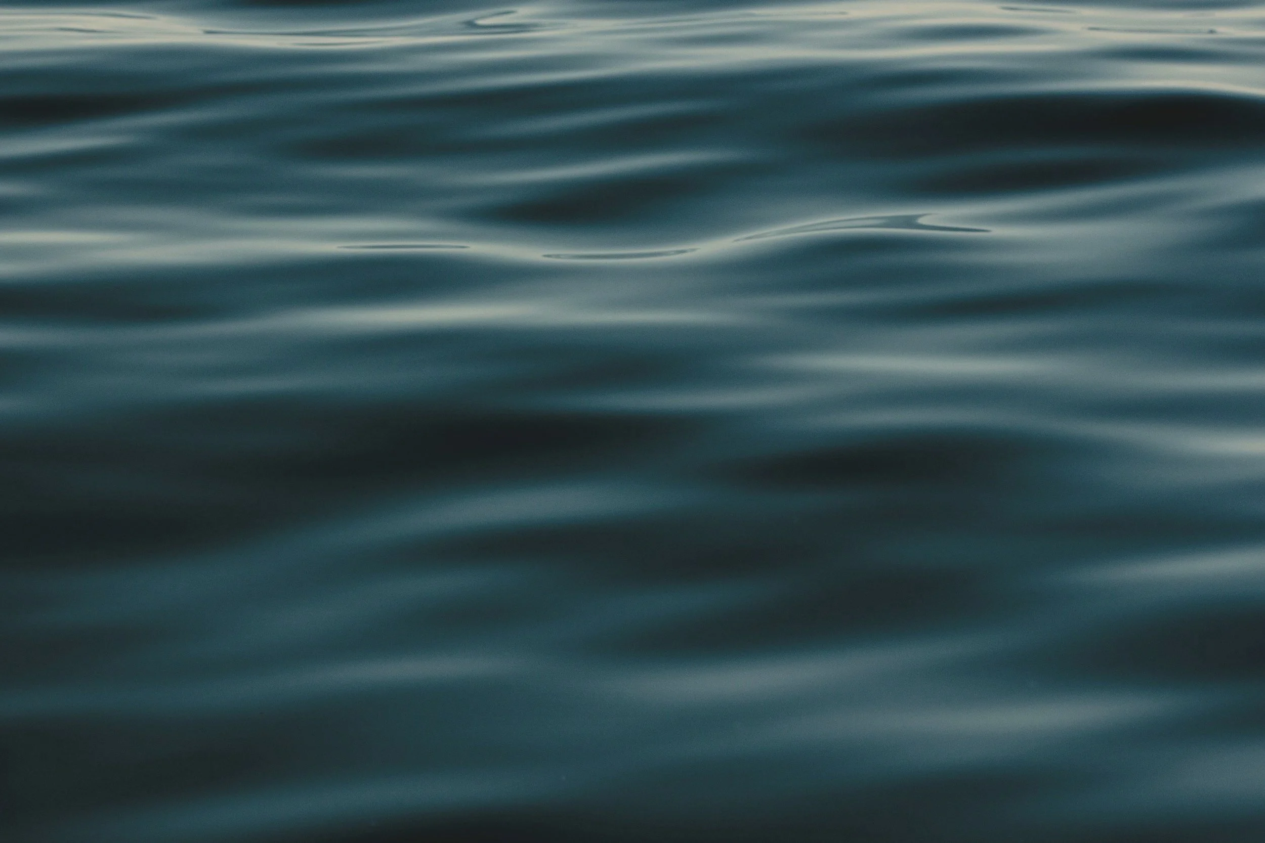 Calm ocean water with gentle ripples on the surface, no visible objects or shoreline.