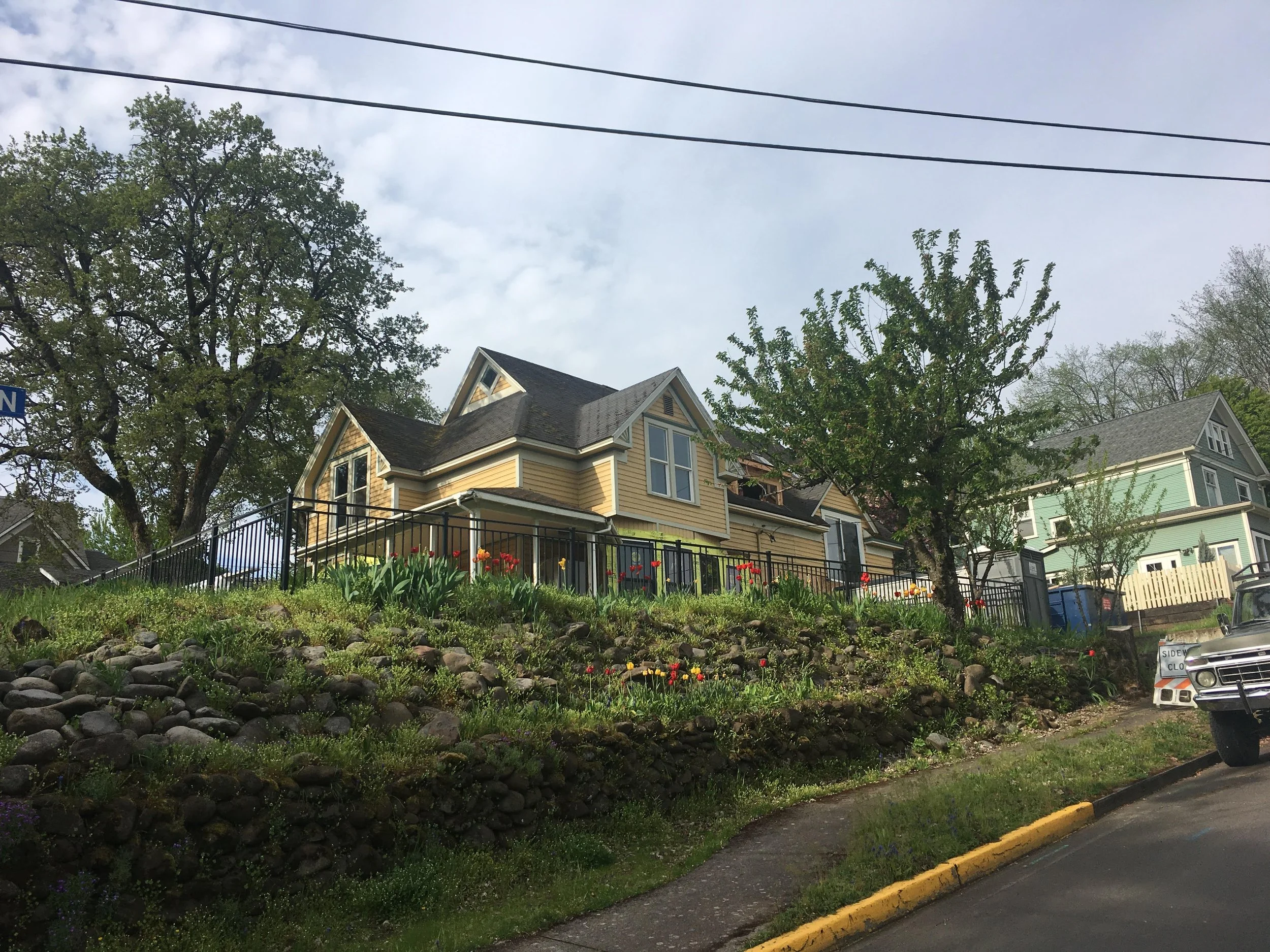 Before picture of Hood River renovation- yellow house with white trim