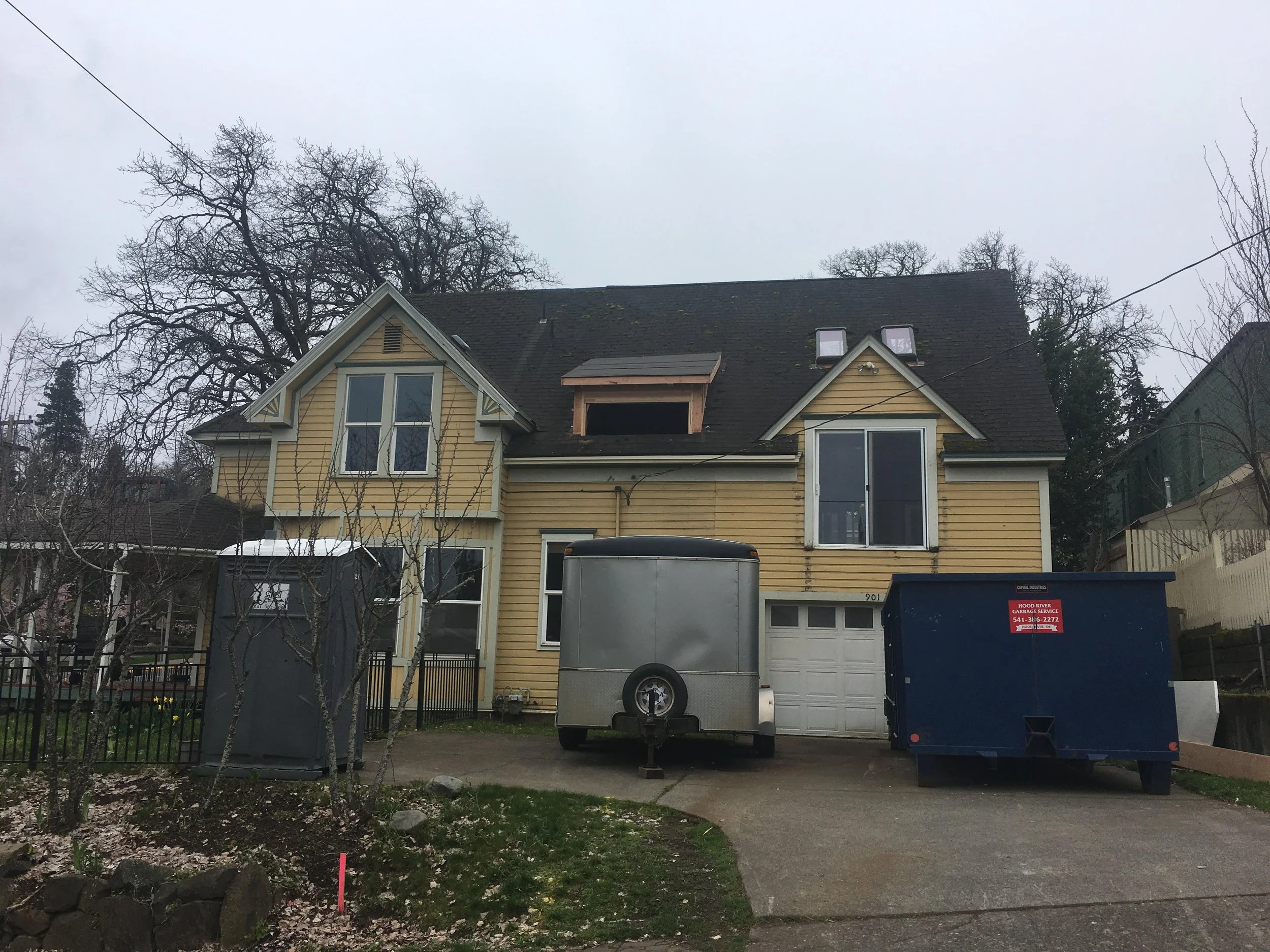 Before picture of Hood River renovation- yellow house with white trim