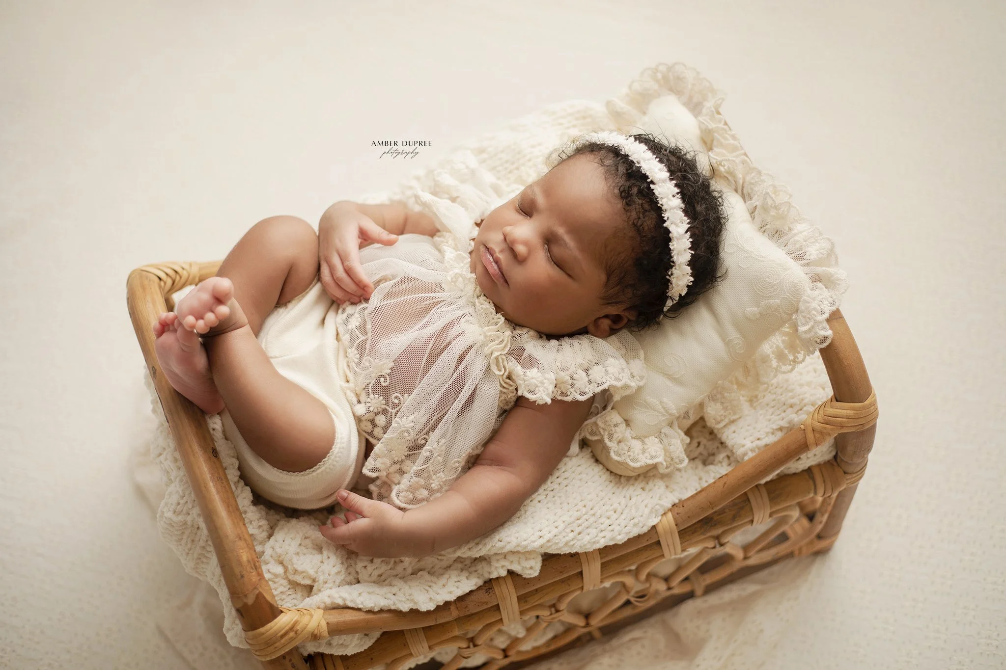 Emotional newborn photography in Nashville TN featuring parents holding their newborn baby in a timeless studio portrait