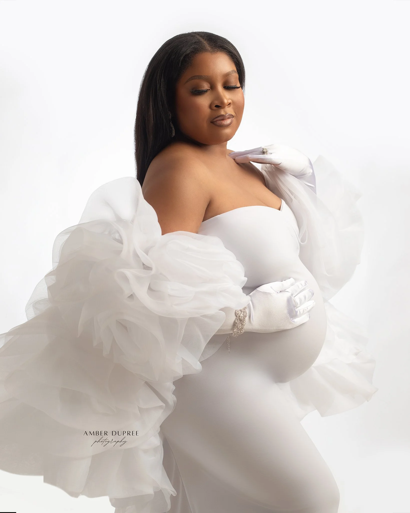 Elegant white maternity photoshoot in Nashville featuring soft backlit lighting