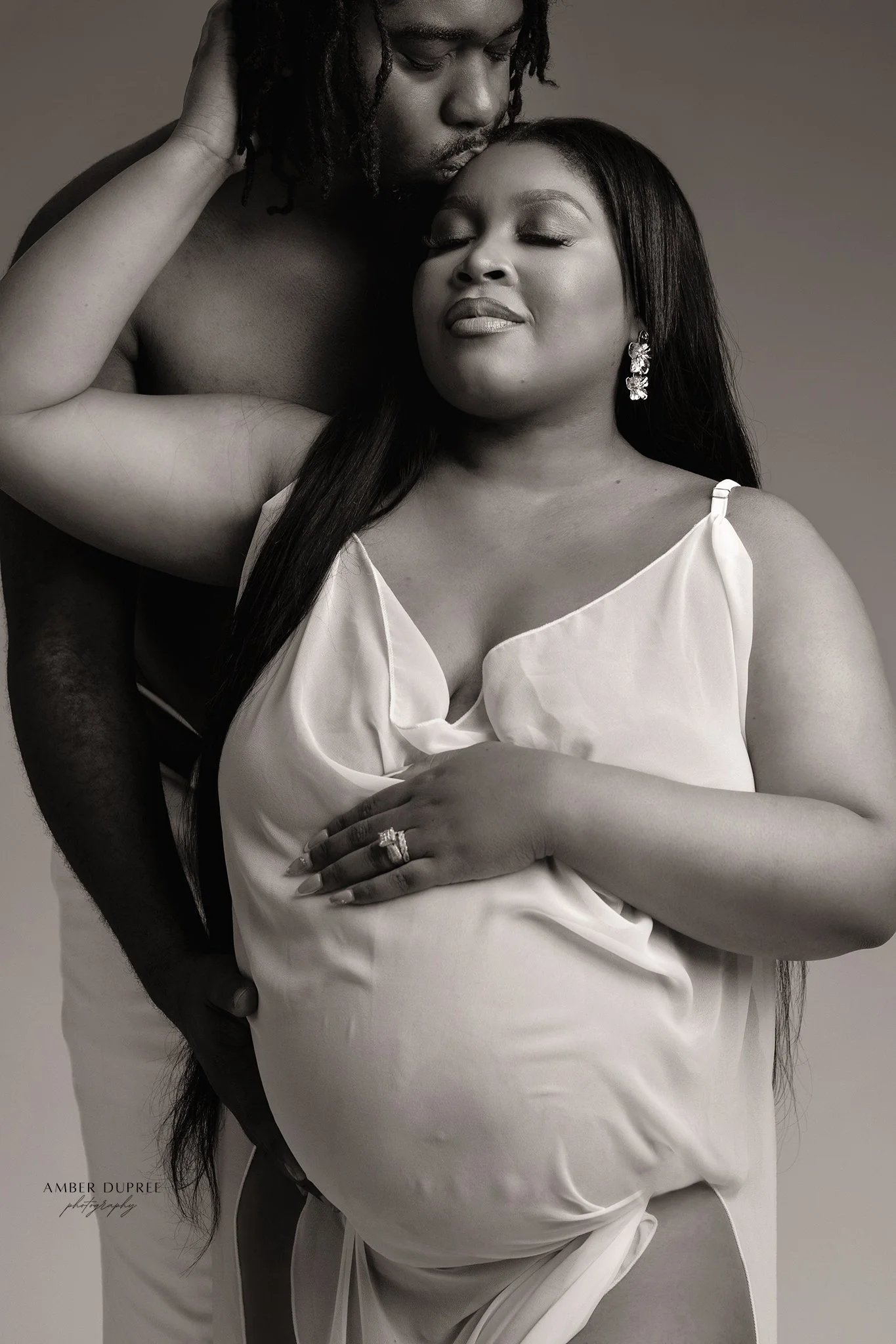 black and white maternity photo with couple posing in nashville maternity photography studio