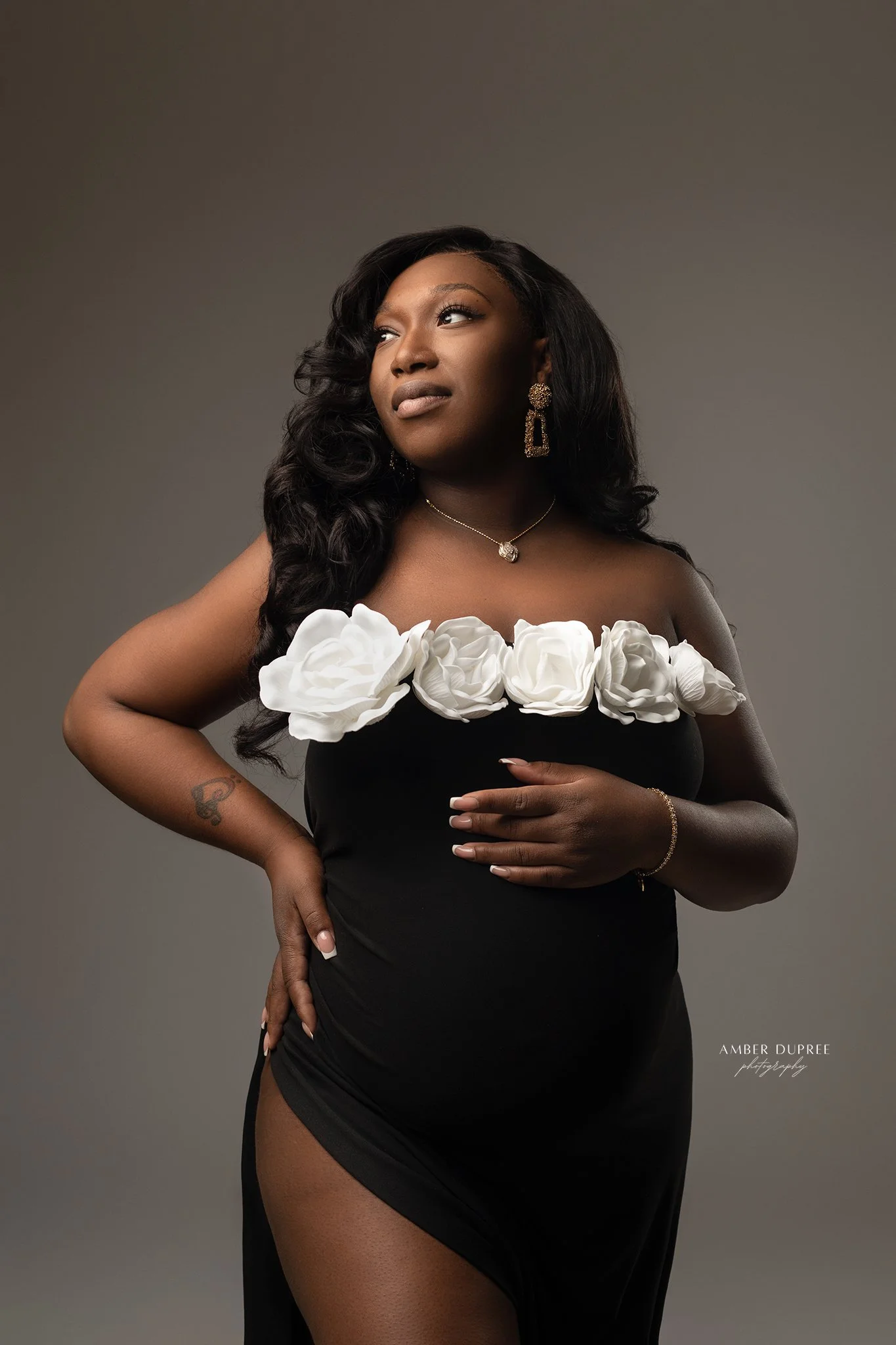 maternity photoshoot with mom in black dress with white flowers