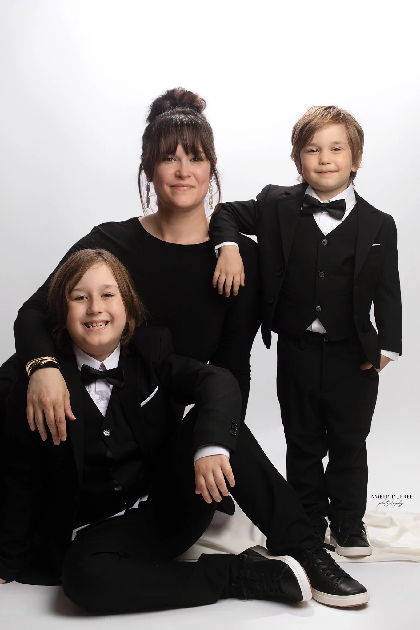 nashville family photographer capturing a photoshoot of a mom and her two boys in tuxedos