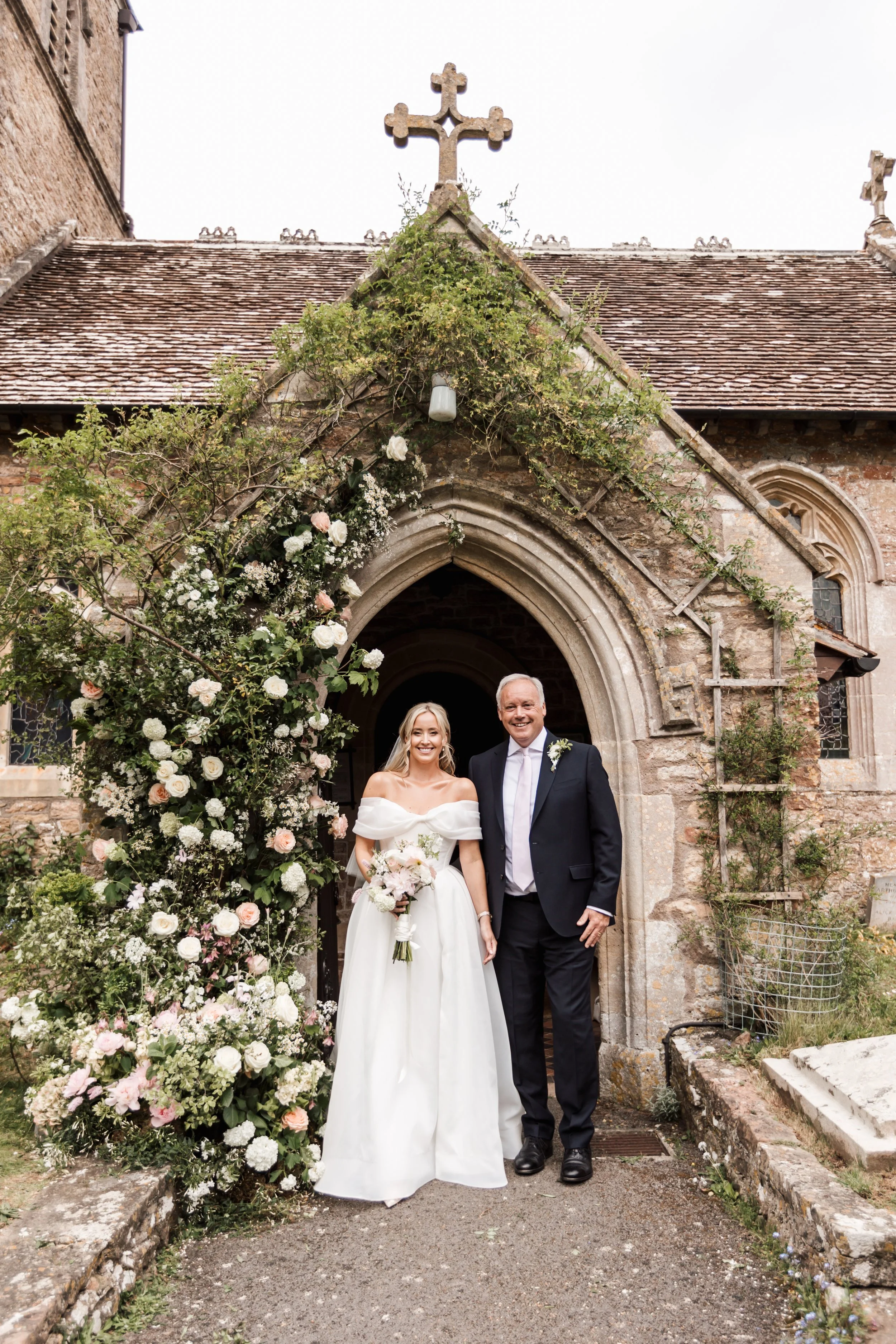 Floral arch at church doorwar