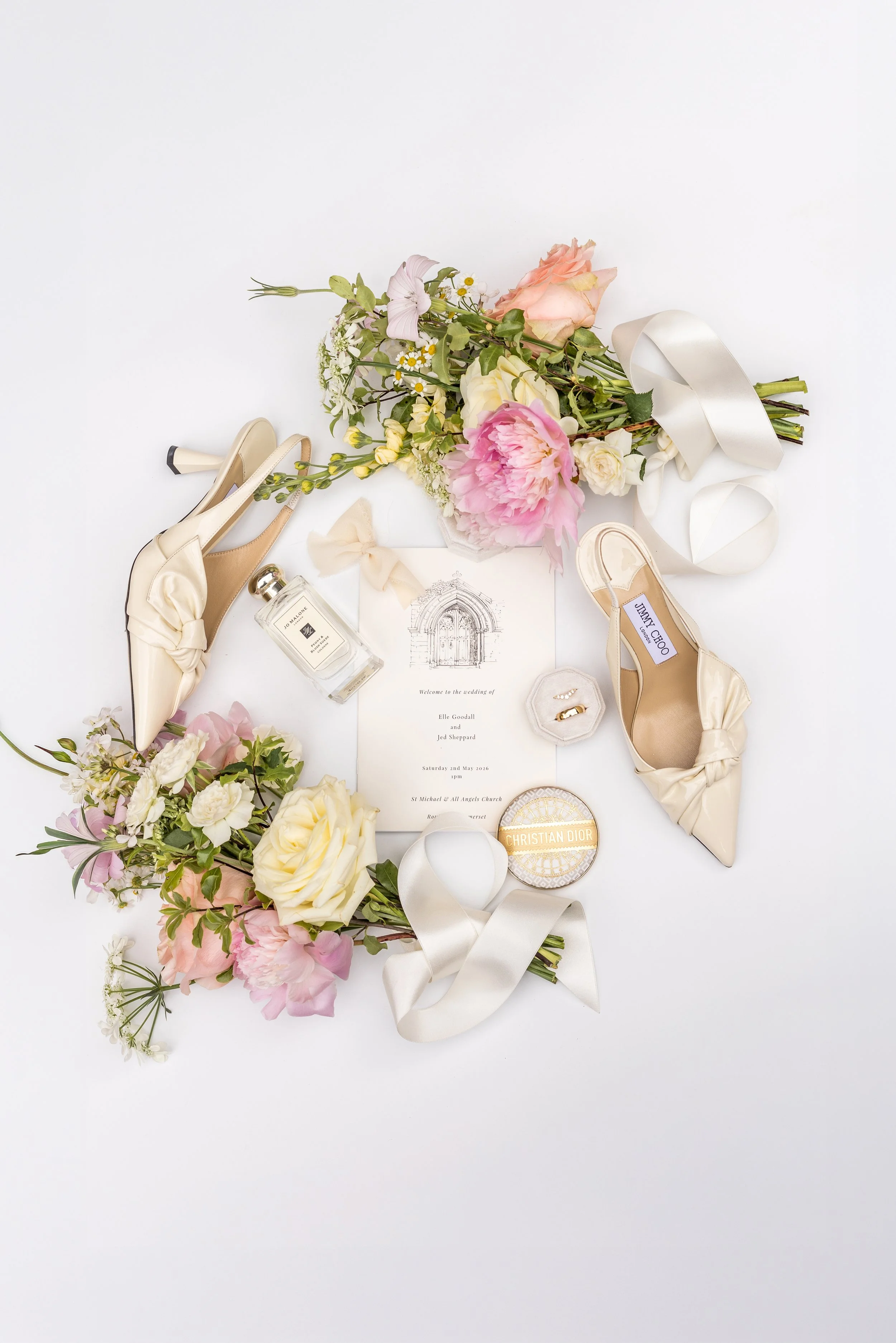 Flat lay wedding flowers shoes perfume