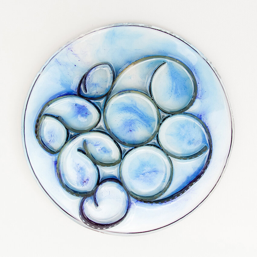   Title: Traces #4 Dimensions: 7” diameter, 1/3” depth Medium: Photographic film, resin, India ink, glass etching medium  