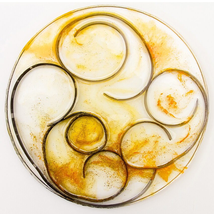   Title: Traces #9 Dimensions: 9” diameter, 1/3” depth Medium: Photographic film, resin, India ink, glass etching medium  