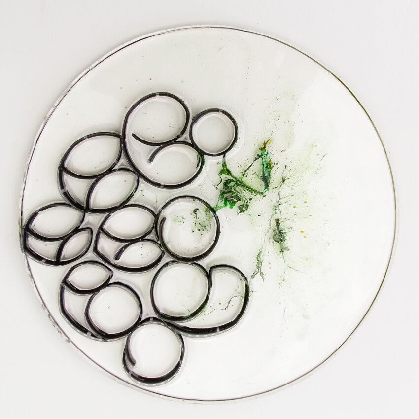   Title: Traces #16 Dimensions: 9” diameter, 1/3” depth Medium: Photographic film, resin, India ink, glass etching medium  