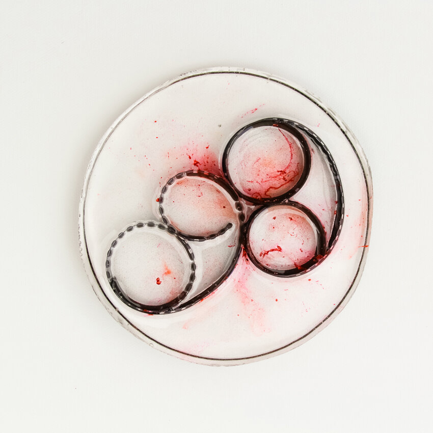   Title: Traces #27 Dimensions: 5” diameter, 1/3” depth Medium: Photographic film, resin, India ink, glass etching medium  