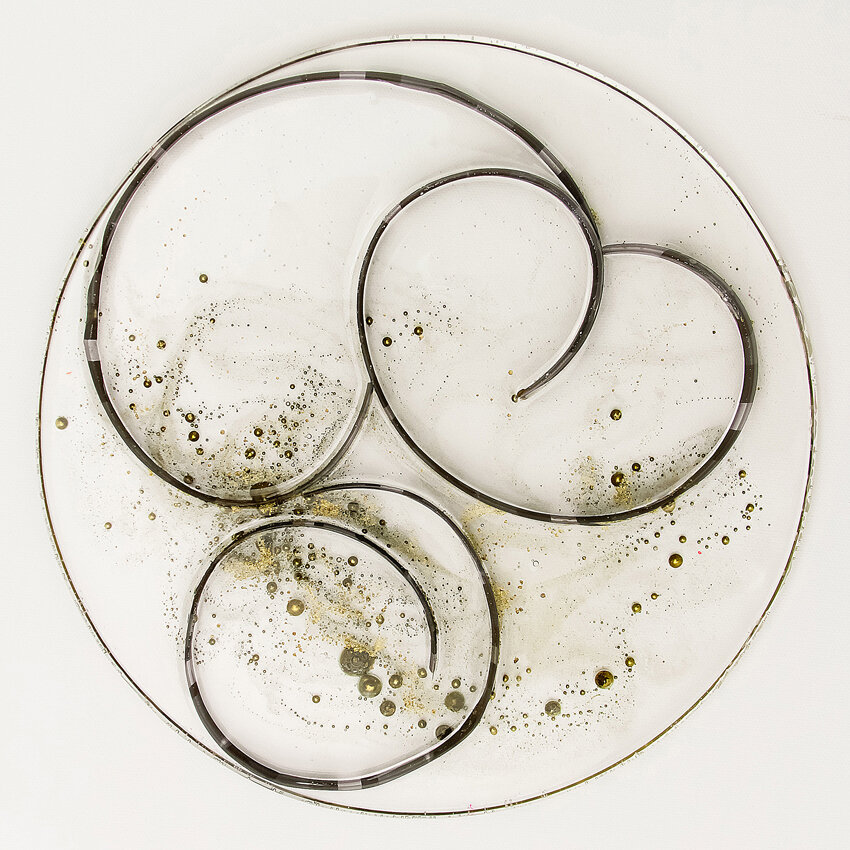   Title: Traces #29 Dimensions: 9”&nbsp; diameter, 1/3” depth Medium: Photographic film, resin, India ink, glass etching medium  