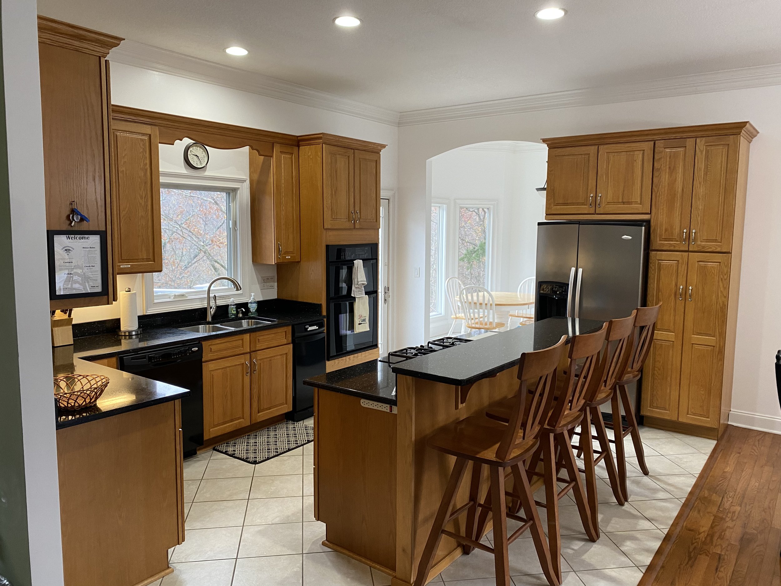 Kitchen area with seating facing the lake and  island cooktop