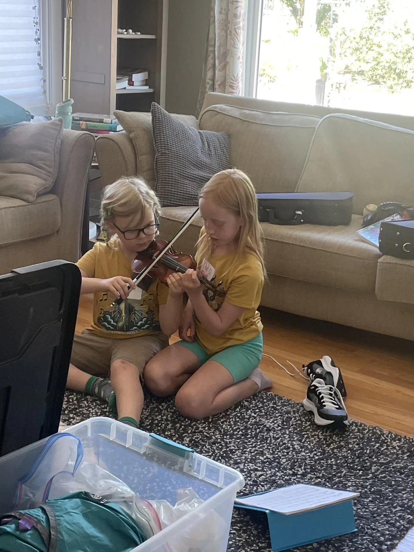Two new Fiddle Camp friends work on their tunes at home!