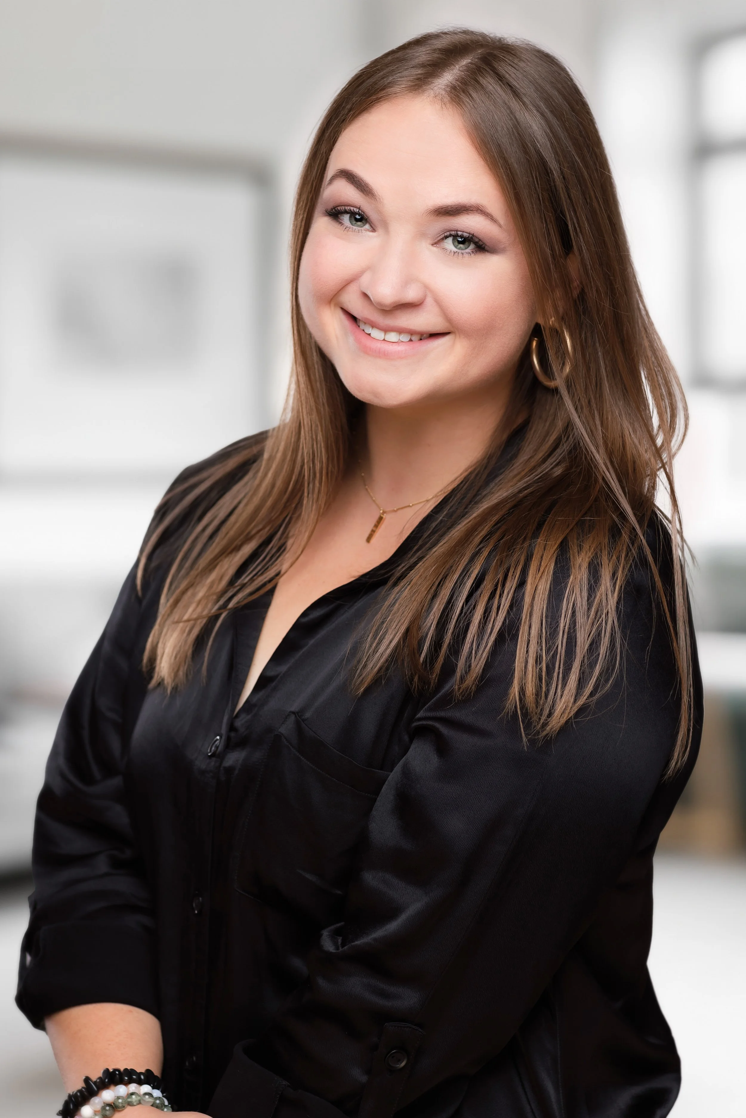 business headshot of a woman smiling looking at the camera