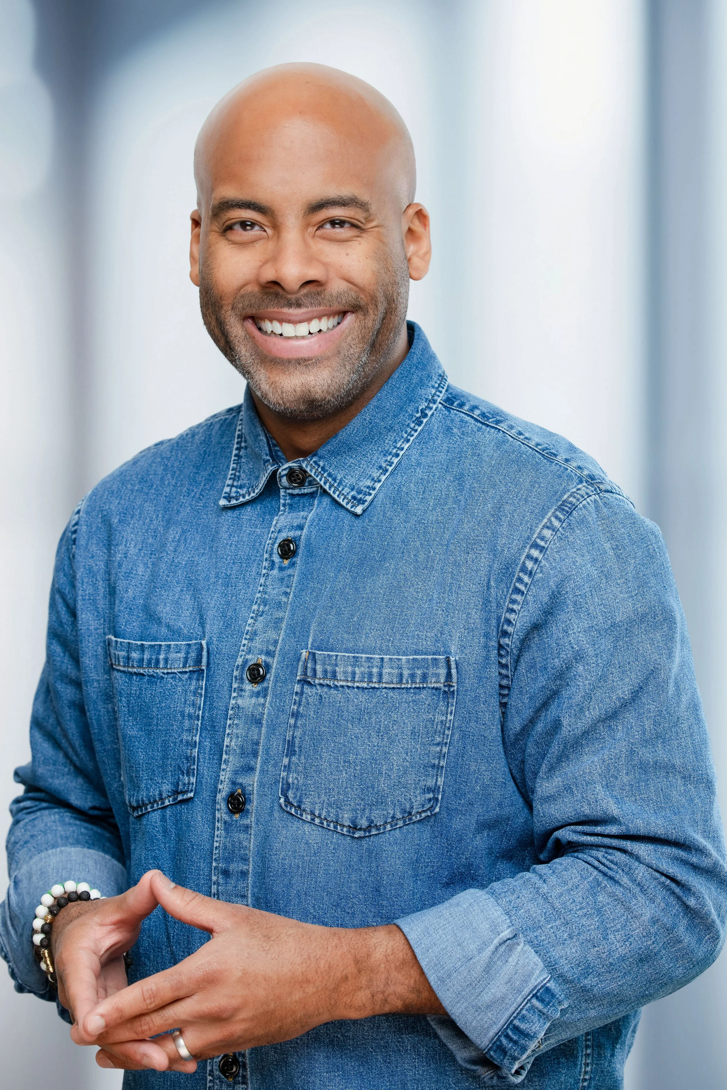 business headshot of a man smiling looking at the camera