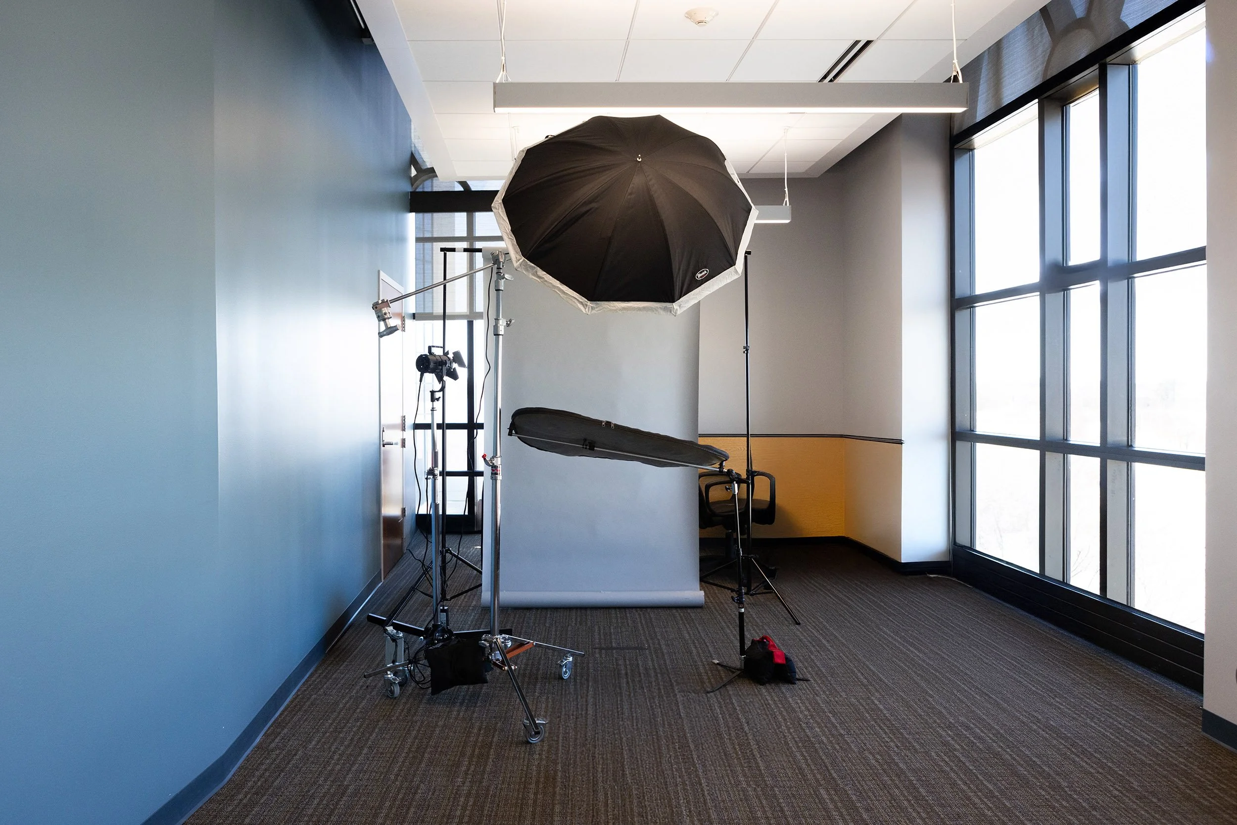 Professional corporate headshot setup with studio lighting in an office setting