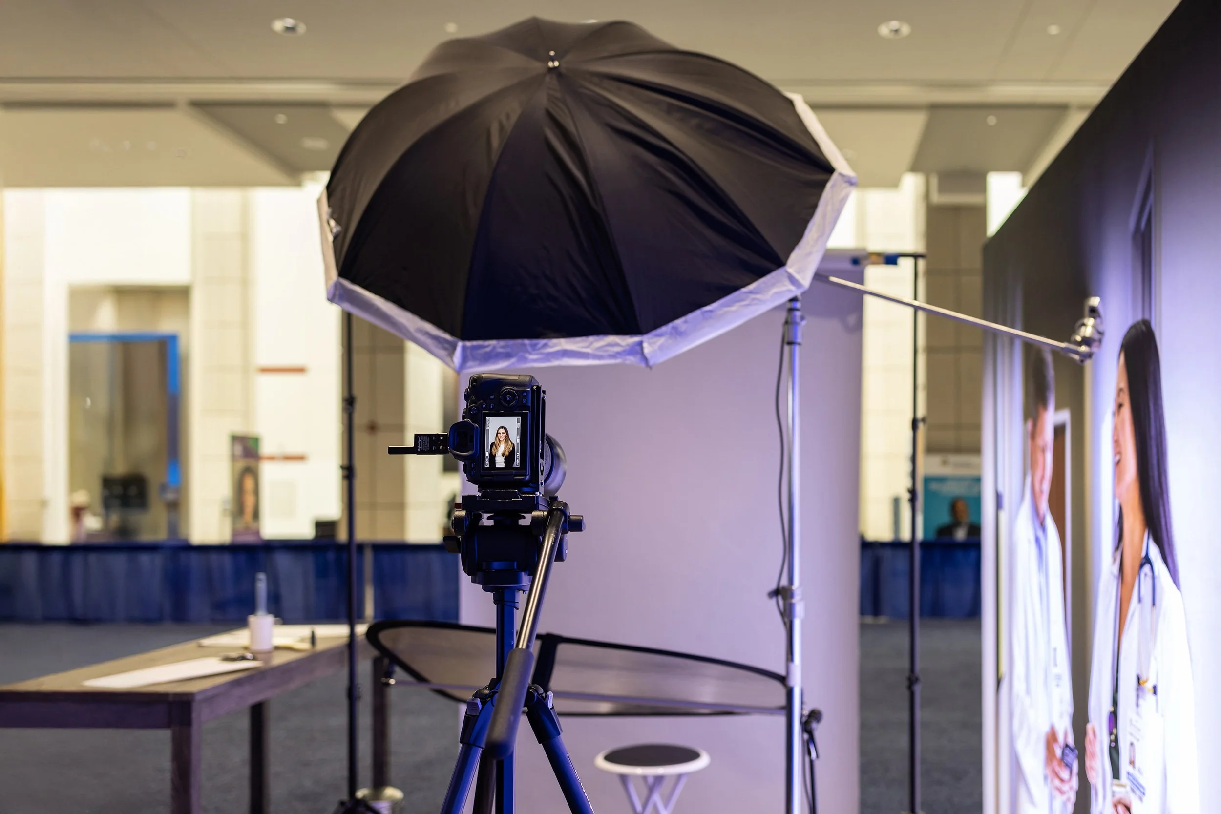 Professional corporate headshot setup with studio lighting at a trade show