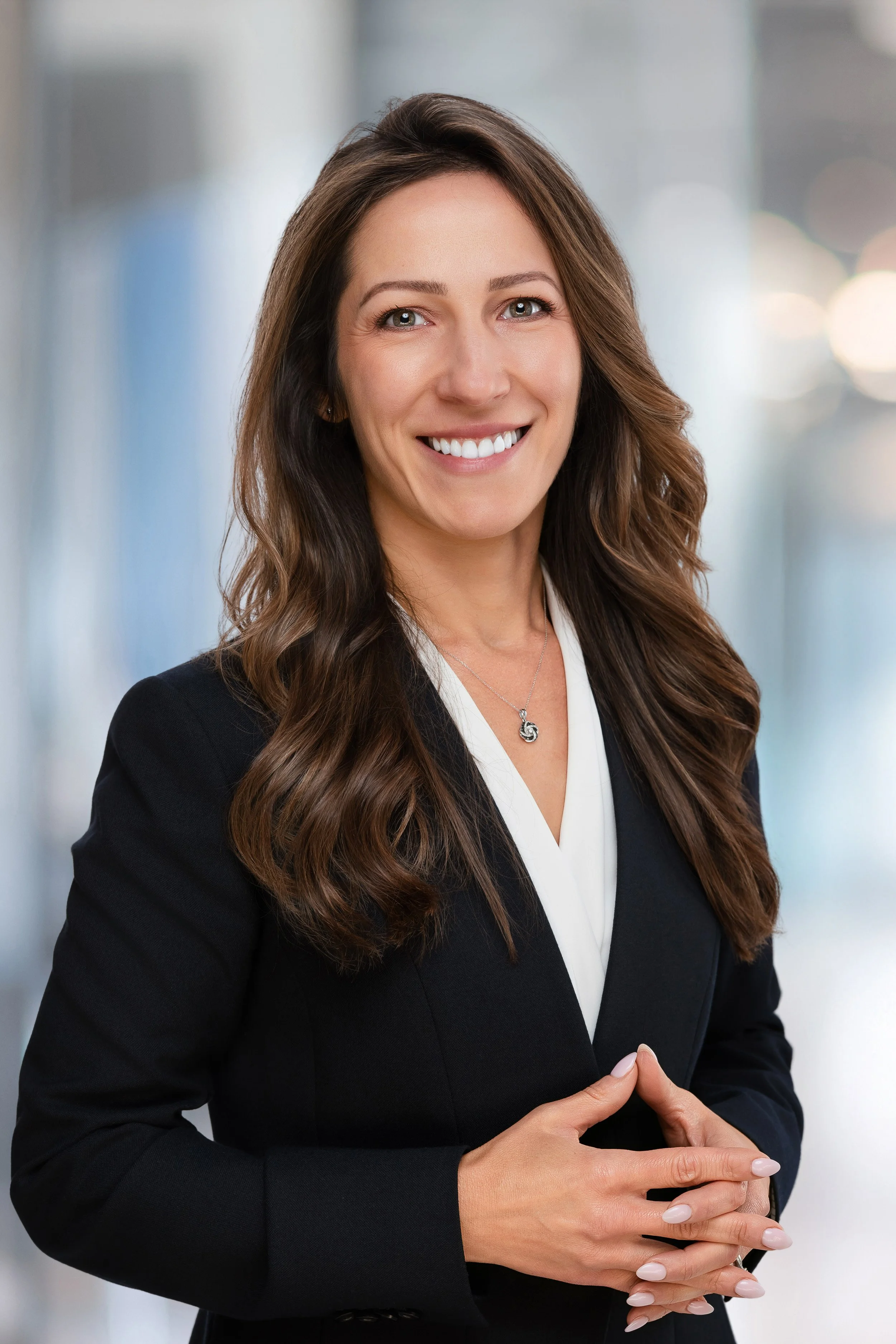 business headshot of a woman smiling looking at the camera