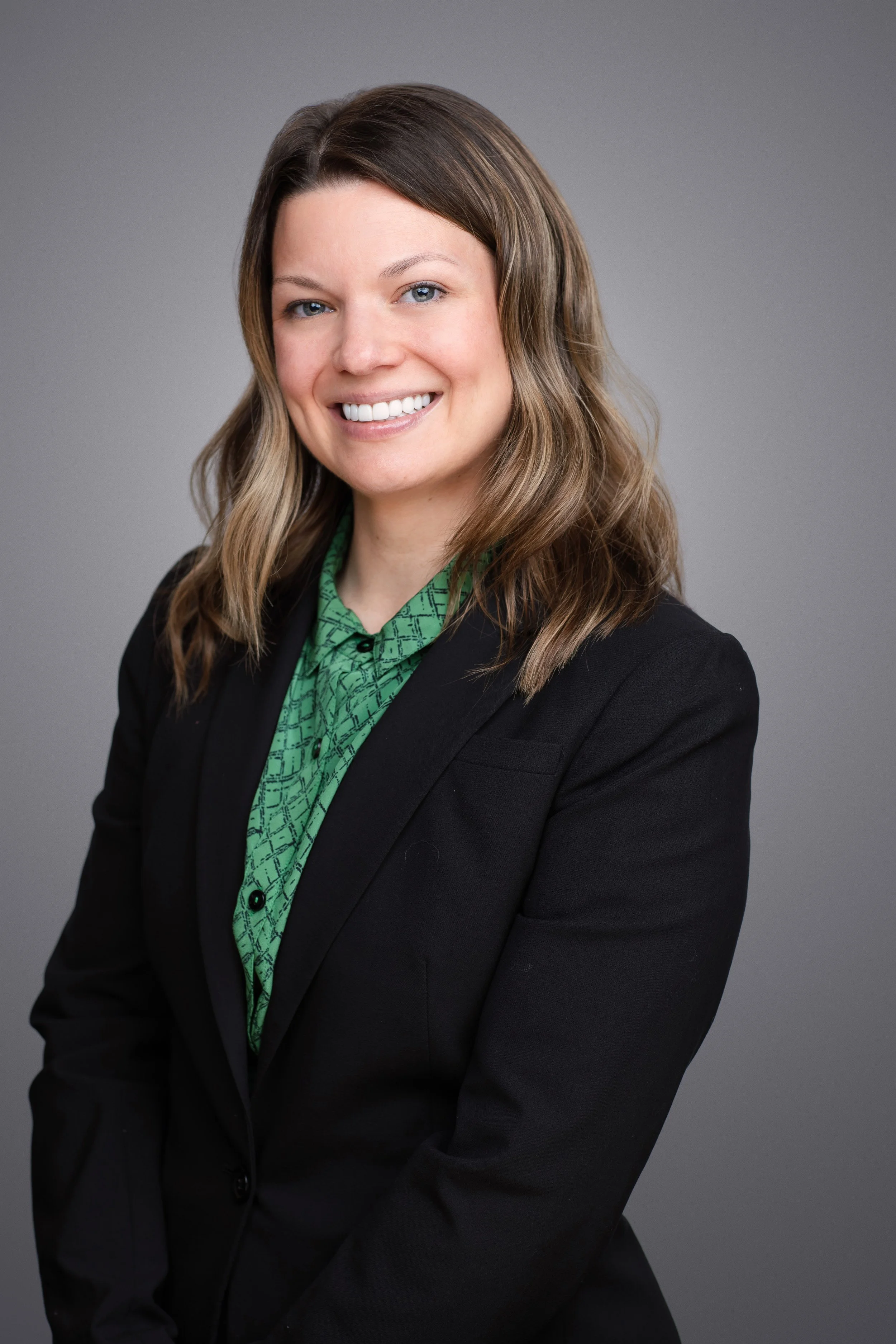 business headshot of a woman smiling looking at the camera