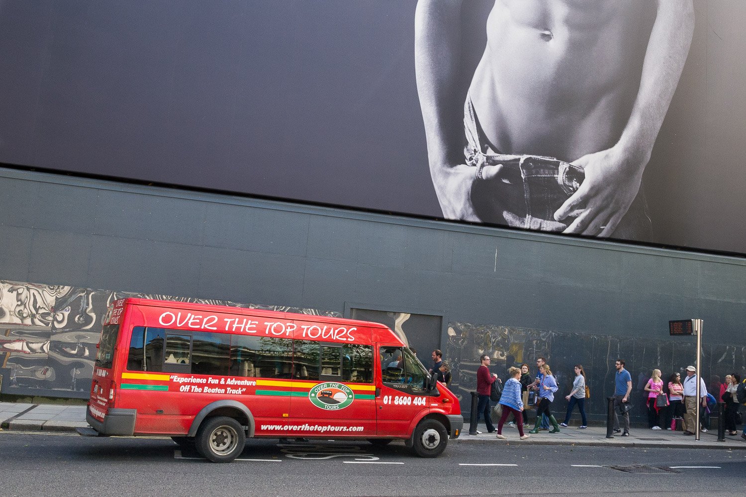  Over the Top. Street Photography, adventure tour bus and large billboard in Dublin Ireland by  Joe Farrell. 