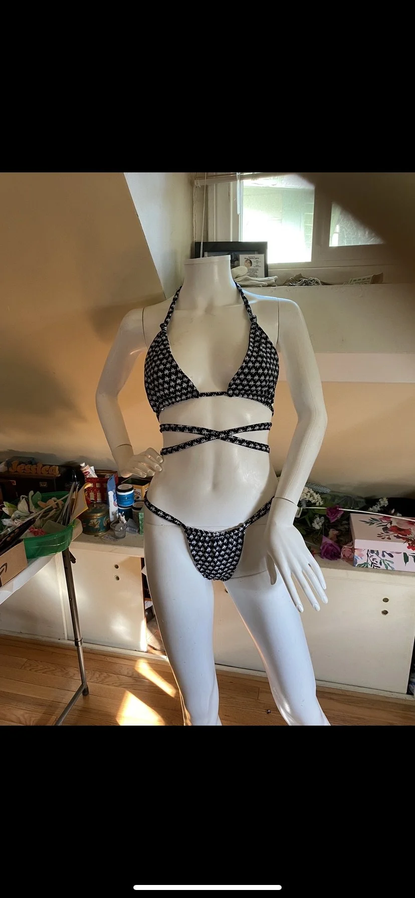 Mannequin wearing black and white bikini with crisscross straps