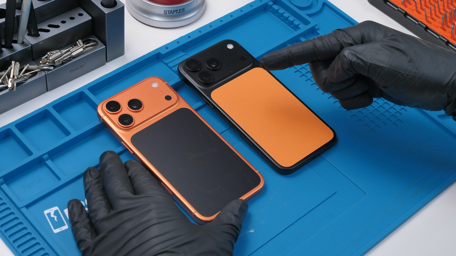 Orange and black iPhones with their contrasting back-glass panels.