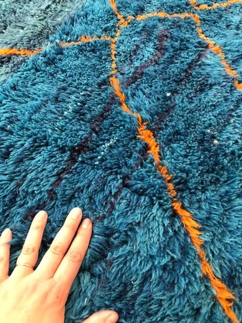 Beni mririt moroccan rug with shades of blue and orange accents 7x9