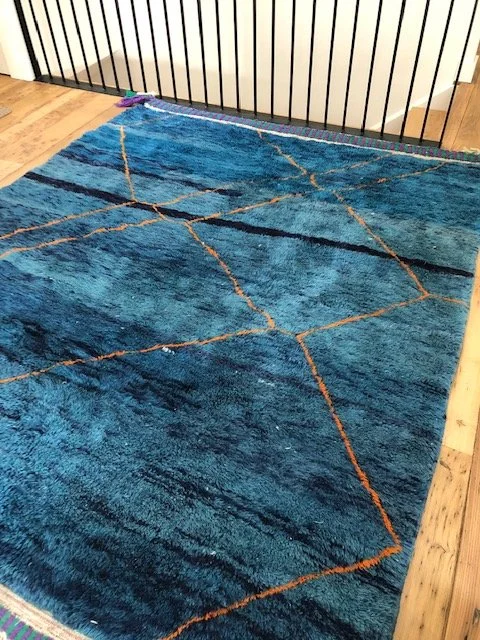 Beni mririt moroccan rug with shades of blue and orange accents 7x9