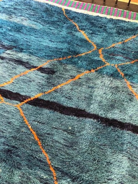 Beni mririt moroccan rug with shades of blue and orange accents 7x9