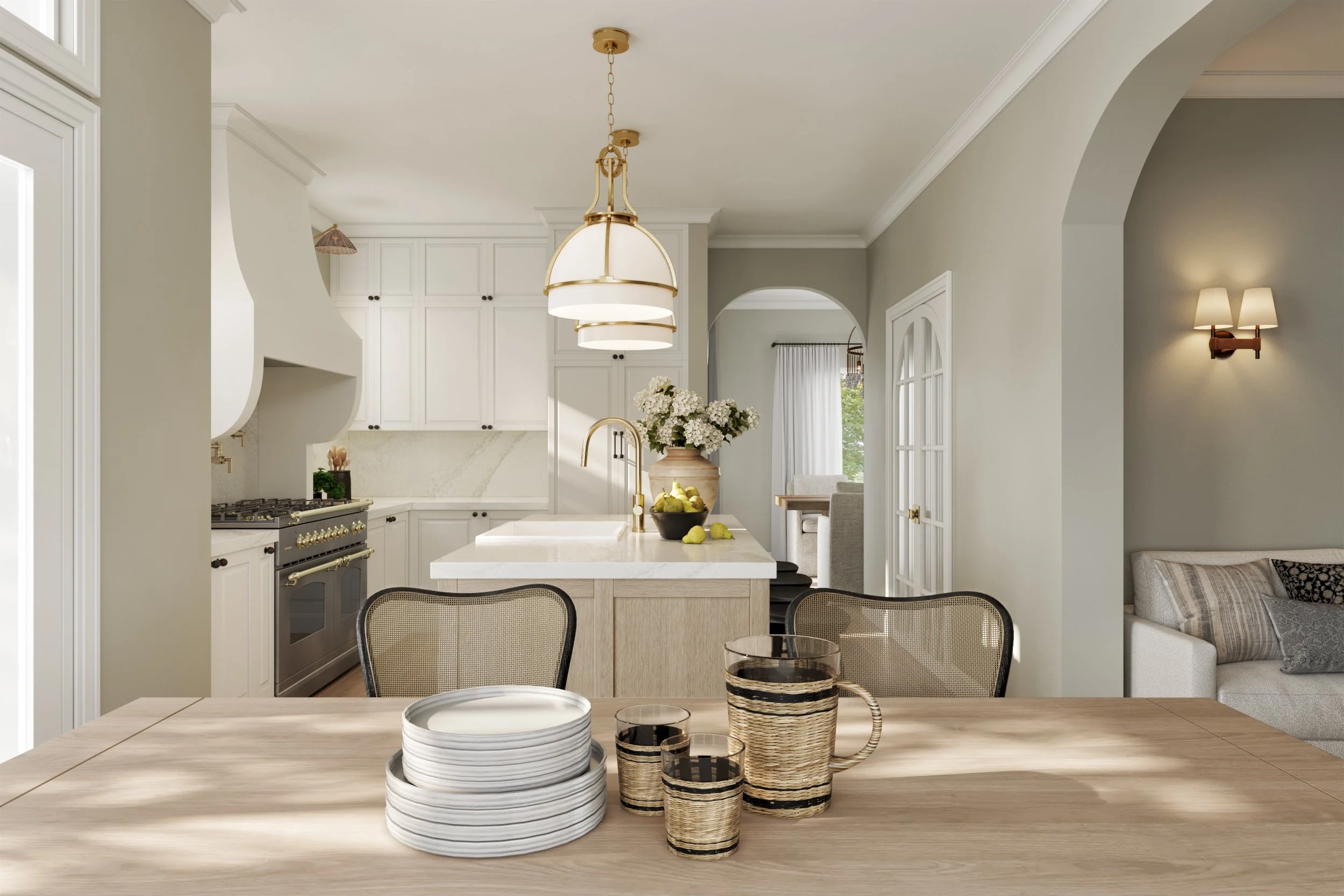 A cozy, bright kitchen with white cabinetry, gold accents, a central island with flowers, and a wooden dining table with plates and glassware in the foreground.