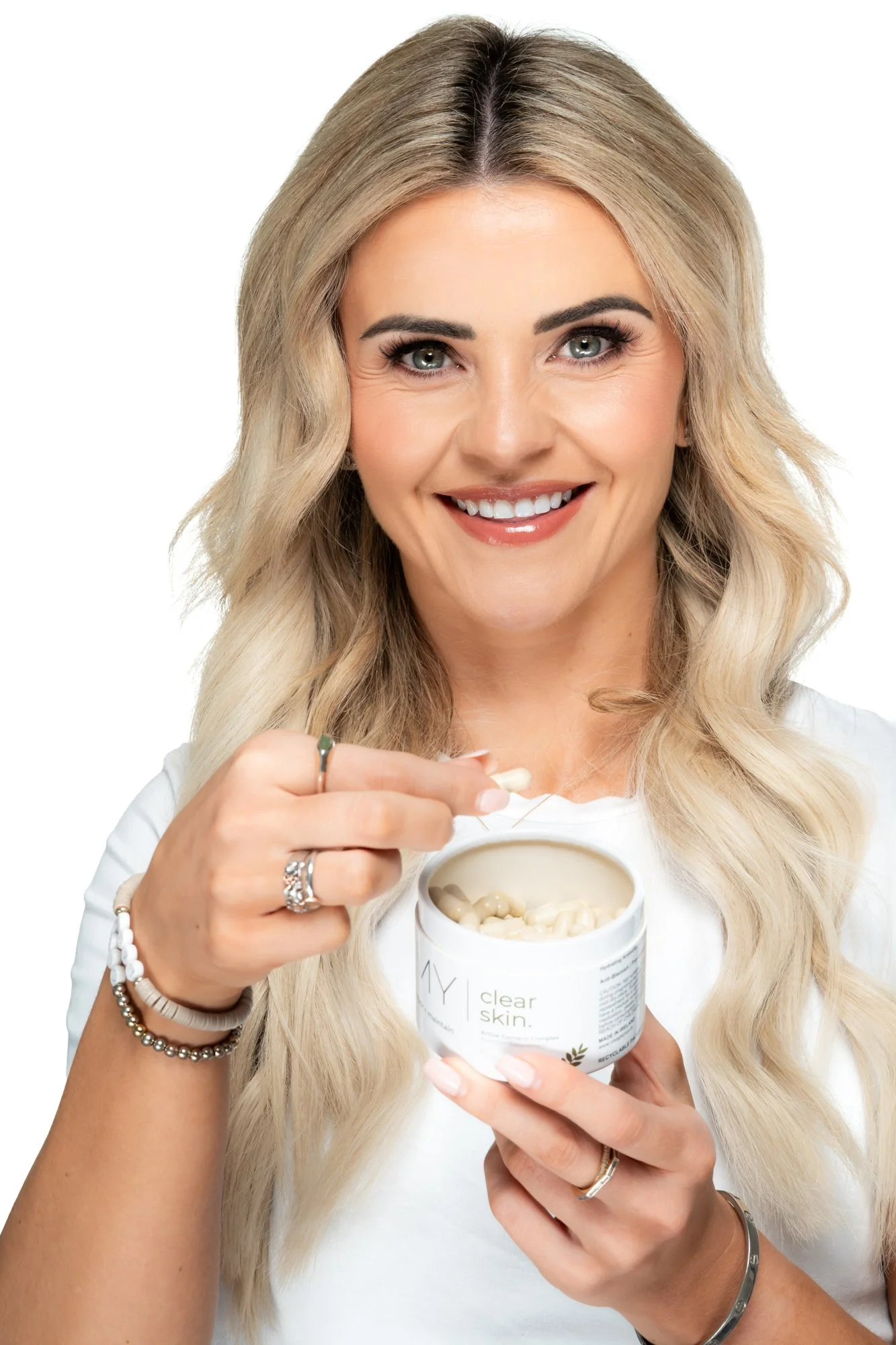 Missy Glow holding open supplement box removing capsule My Visage Nutra Glow product photography white background