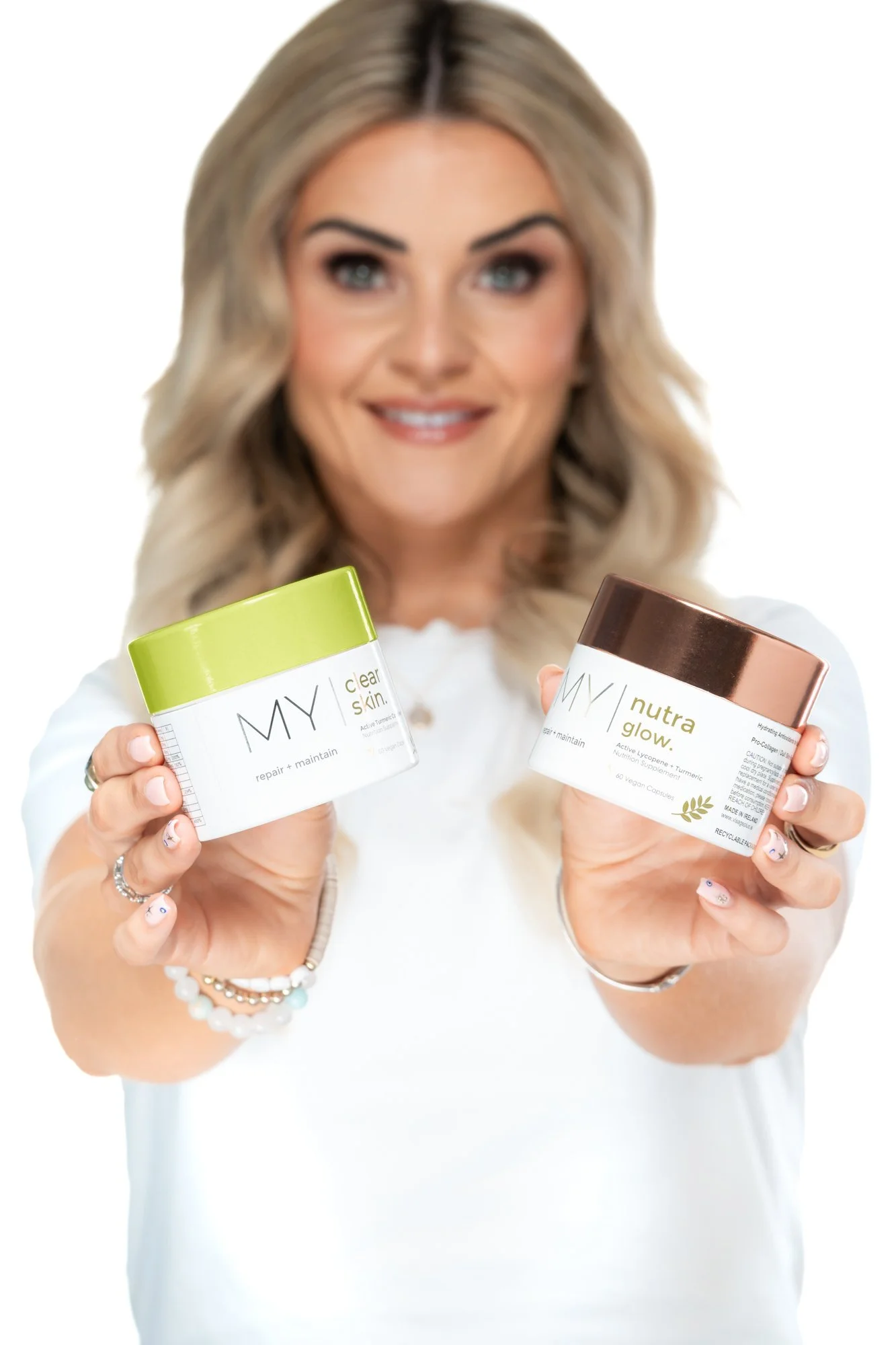 Rachel Rice influencer portrait holding My Visage Clear Skin and Nutra Glow nutrition supplements clean white backdrop
