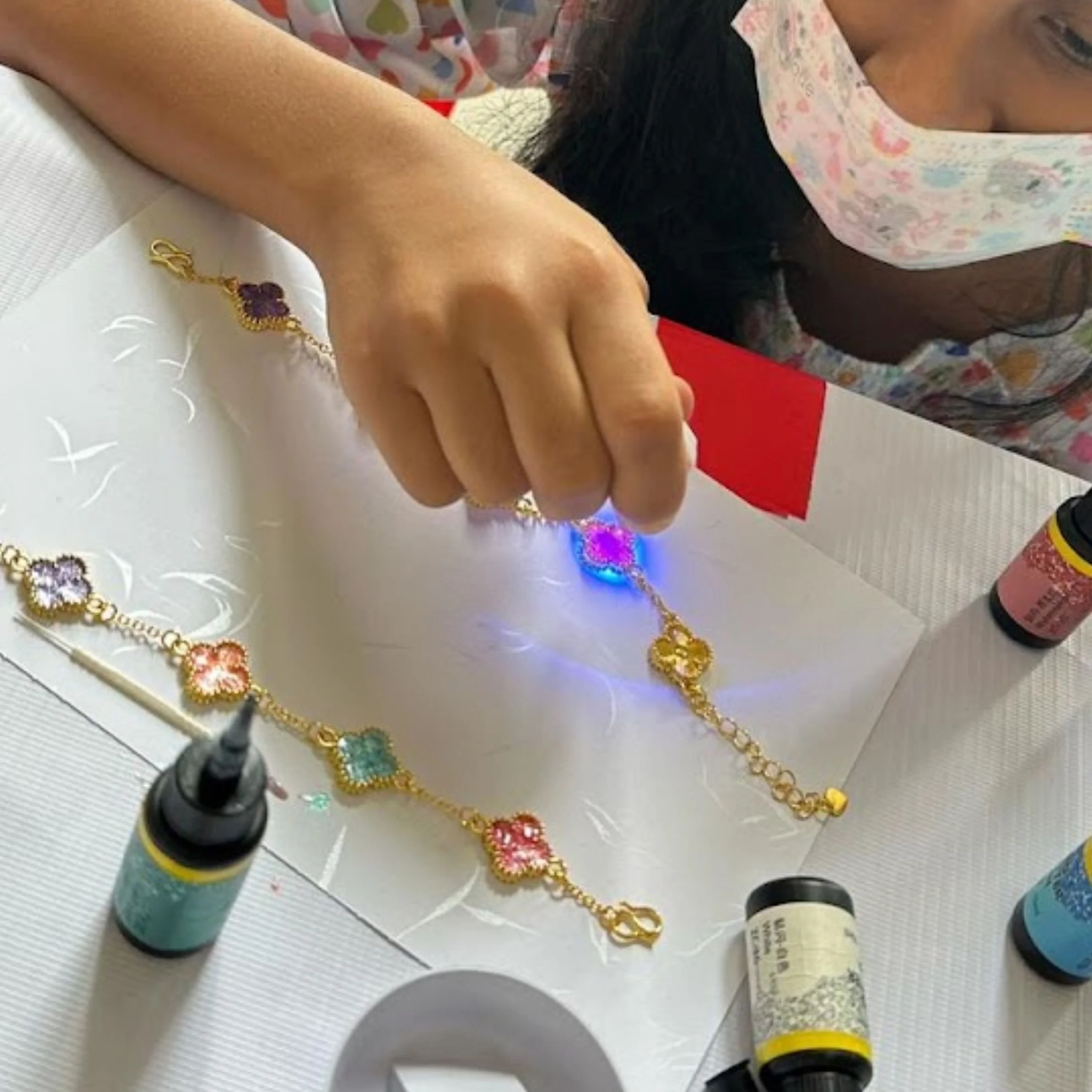 Participants making resin jewellery at a community block party in Singapore.