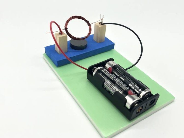 DC motor project with battery and wires used in a school STEM workshop