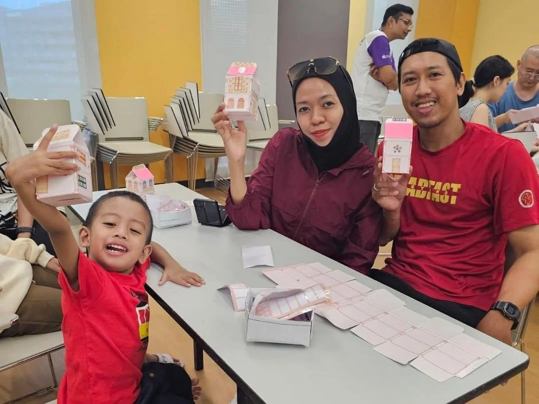 Family participating in an inclusive hands-on community event workshop in Singapore