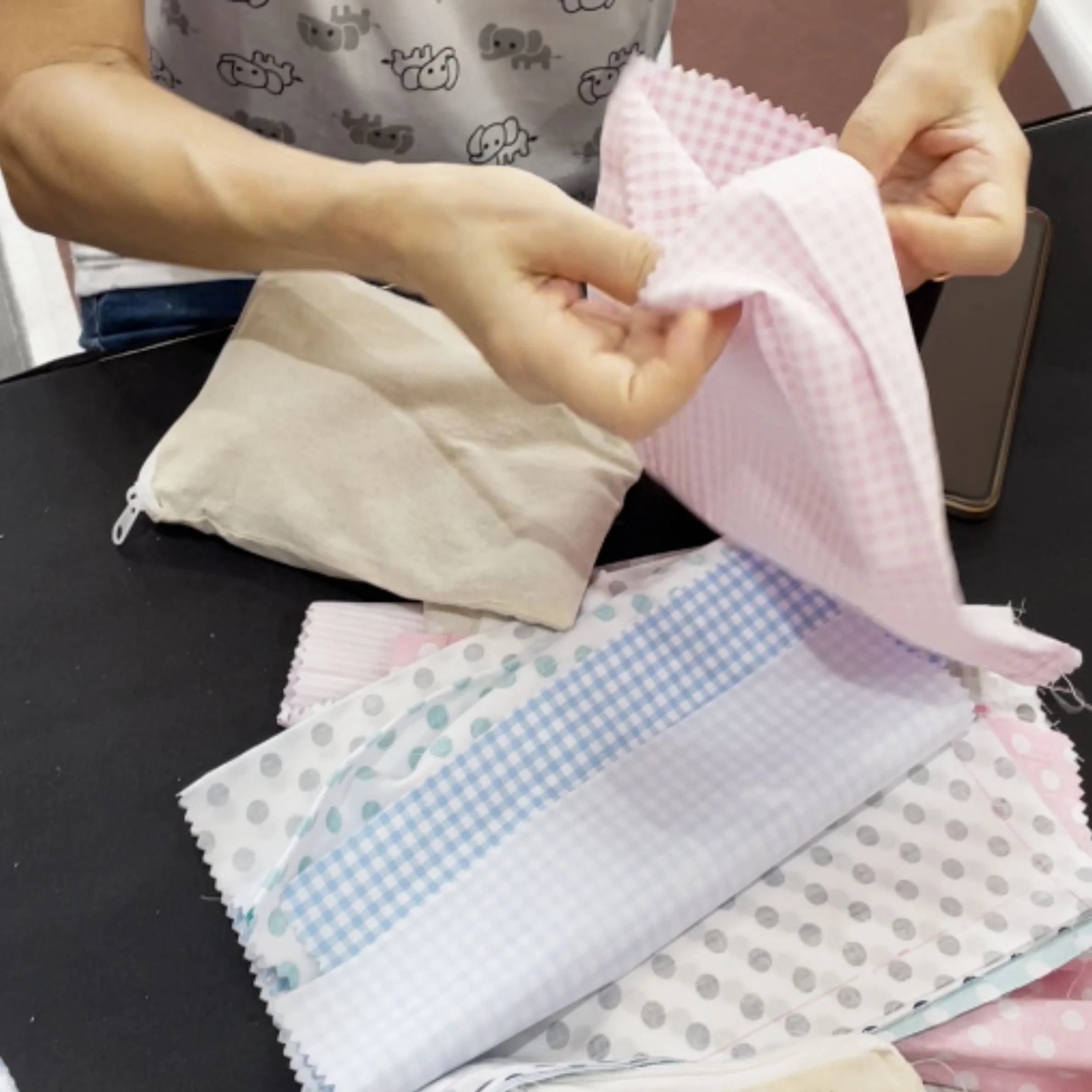 Participants using recycled fabric to make herbal heat packs at an SPD ESH workshop in Singapore.